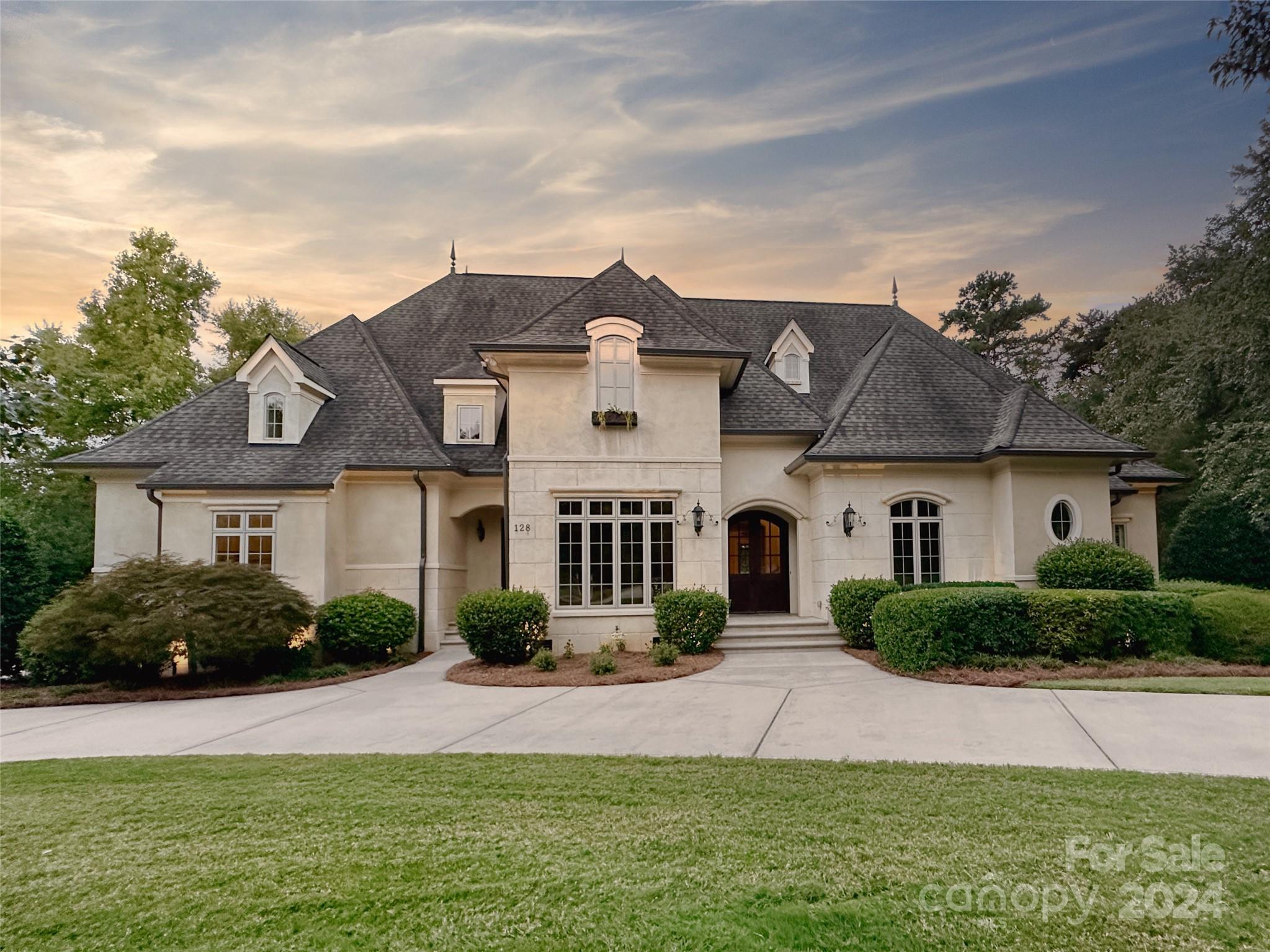 Experience luxury Lake Norman real estate at The Point! This stunning European-style home offers breathtaking waterfront views and is situated on a prime golf course lot. Recently updated with fresh paint and freshly painted cabinetry, gorgeous hardwoods throughout most, this two-story home features a chef's kitchen with high-end appliances, a large island, and serene lakefront views. The main-level primary suite boasts a spacious walk-in closet and tranquil vistas. Enjoy outdoor living and alfresco dining on the expansive screened porch, overlooking a sparkling pool, large fenced yard, and lush landscaping. The upper level includes three additional bedrooms, three bathrooms, a media room, a bonus room, and a second laundry room. With a deeded, renovated boat slip just steps away, you'll have easy access to Lake Norman. Trump National Golf Club Charlotte, offers premier golf, tennis, pickleball and more, just minutes away. Discover the ultimate Lake Norman lifestyle today.
