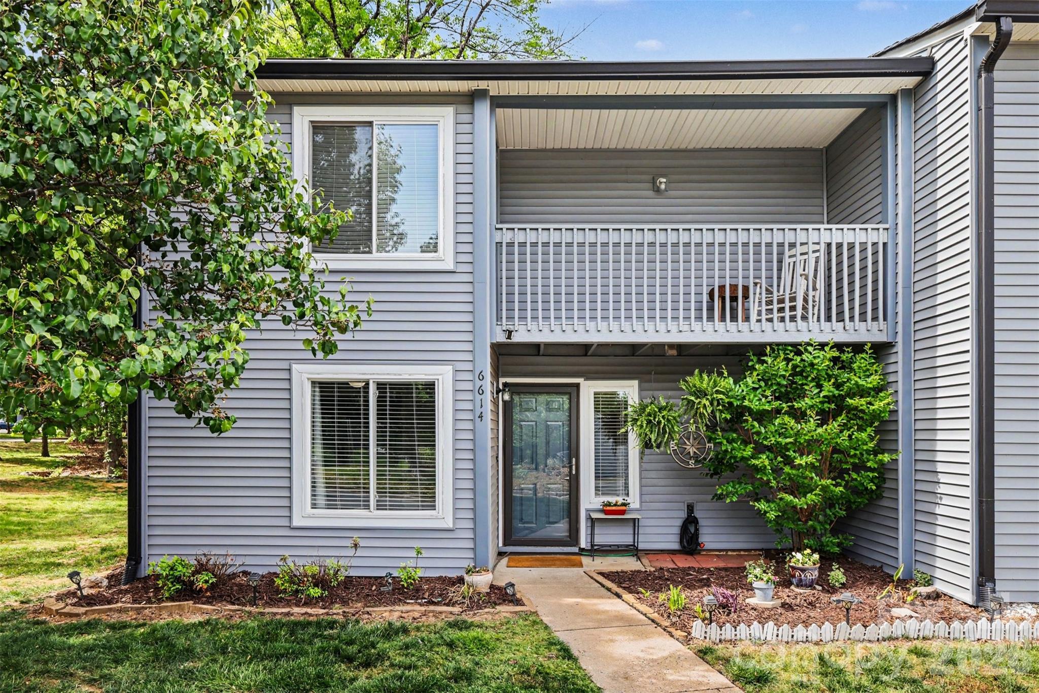 Tucked within the established Carmel Chace community in South Charlotte, this inviting two-story condo offers a blend of comfort, character, and an unbeatable location. Surrounded by mature trees and thoughtfully landscaped grounds, the setting feels peaceful and private while still being moments from some of the area’s most desirable shopping, dining, and everyday conveniences.

Inside, the home opens to a warm and welcoming living space filled with natural light and anchored by a cozy fireplace, creating an ideal setting for both relaxing and entertaining. The layout flows seamlessly into the dining area and kitchen, where rich cabinetry, stylish backsplash details, and thoughtful design provide both function and charm. Sliding doors lead to a private outdoor retreat, complete with a deck and balcony overlooking lush greenery—perfect for enjoying quiet mornings or unwinding at the end of the day.

Upstairs, each bedroom offers its own private en-suite bath, creating a comfortable and functional layout that’s well-suited for privacy and everyday convenience. The bedrooms are spacious and inviting, complemented by updated finishes and a calming, neutral palette throughout. A flexible main-level space provides options for a home office or additional living area, adding versatility to the home.

Carmel Chace is known for its quiet, tucked-away feel while remaining exceptionally convenient to SouthPark, Ballantyne, and major thoroughfares, making commuting and access to top retail and dining effortless. This home presents a rare opportunity to enjoy low-maintenance living in one of Charlotte’s most sought-after and centrally located communities