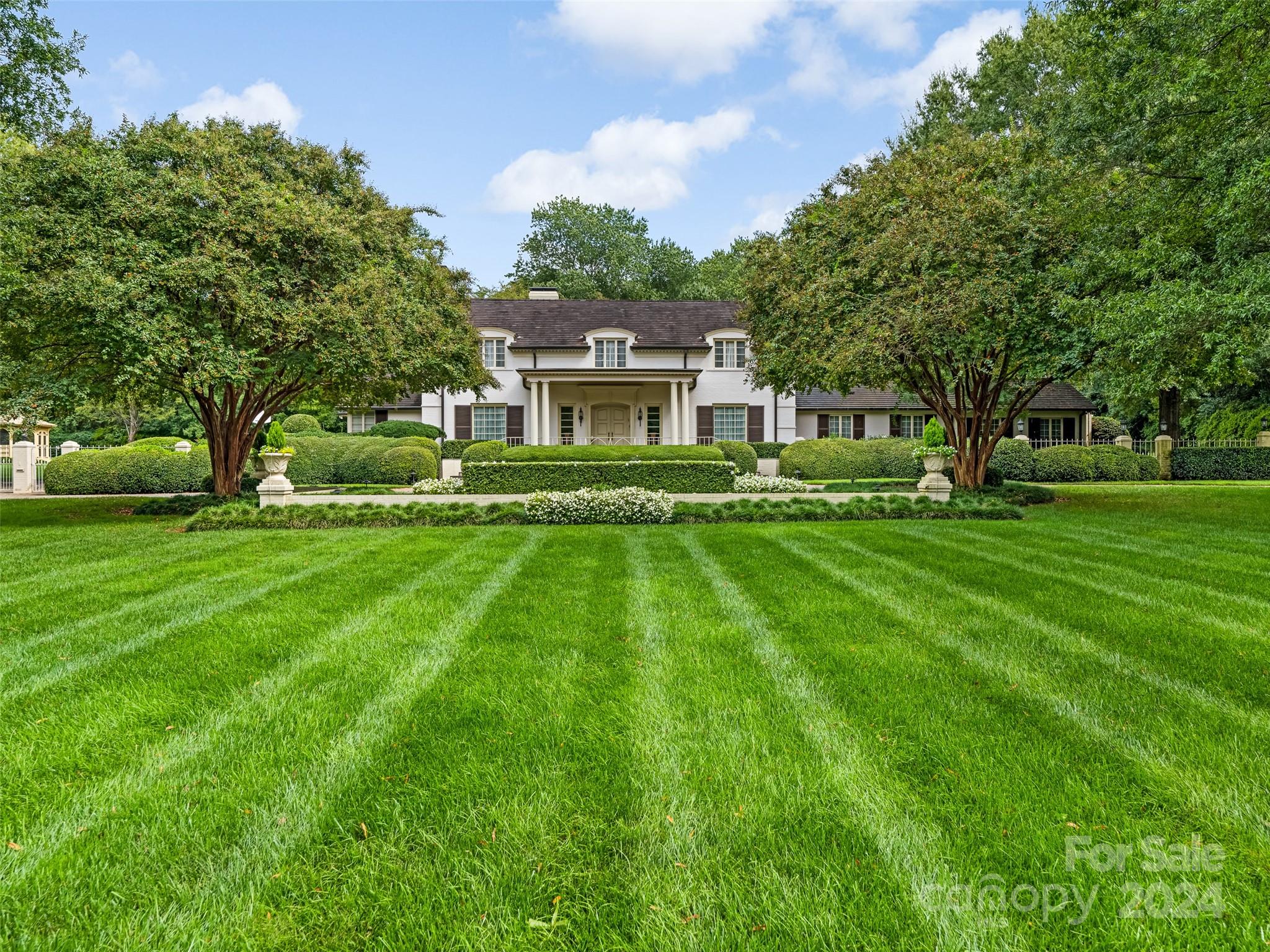 Amazing opportunity to purchase one of a kind estate home in the heart of Southpark on just under 3 acres of land. Meticulously maintained professionally landscaped private yard with circular drive, gated access to 3 car garage, and indoor swimming pool with hot tub. This property with its park like setting is in great location within minutes of shops, restaurants, and retail.  Main house features ample space for entertaining with bar area, and easy access to exterior garden and terraces. Large windows and abundant natural lighting with custom molding, built-in cabinetry and private primary suite on main level with large bath and closets. Gracious formal areas and practical floor plan which also features a guest suite on the main level with private entrance. All bedrooms have private bath.