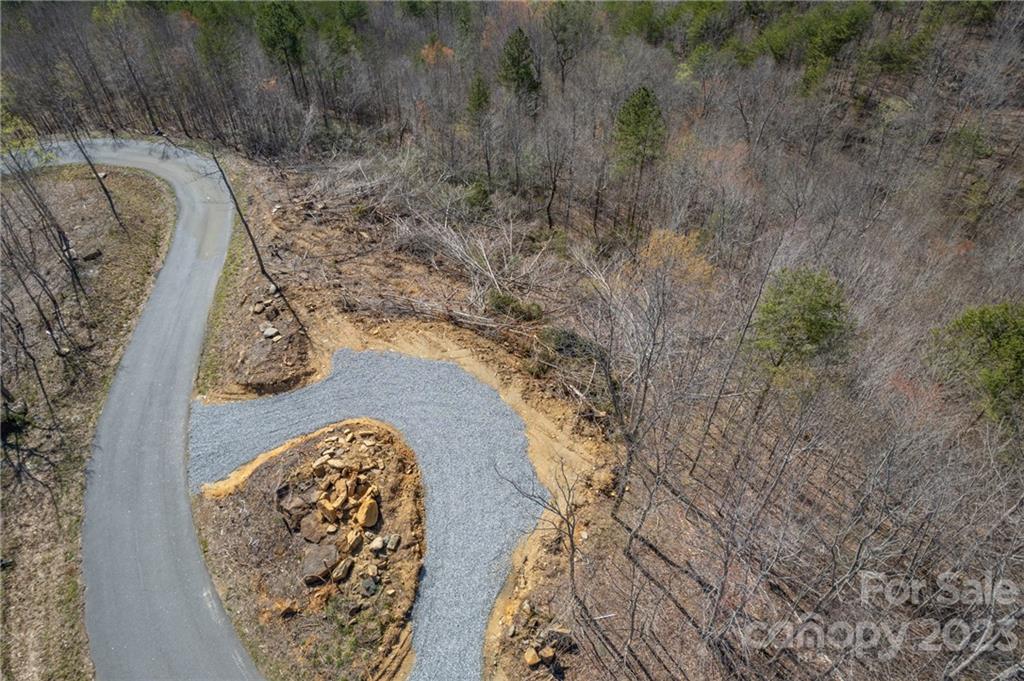 Amazing views and priced to sell! If you are looking for the perfect spot to build a home that allows you to experience breathtaking sunsets and natures beauty daily, this is it! Located in the gated Great Sky subdivision (formerly Queens Gap), you'll have a long range mountain views of Shumont Mountain and Mount Mitchell, and access to underground utilities and public water. Trees have been partially cleared to open up the view and a new gravel driveway is already in place. All that's left is choosing your homesite! The view from this property must be experienced to fully appreciate the beauty. Don't miss this gem!