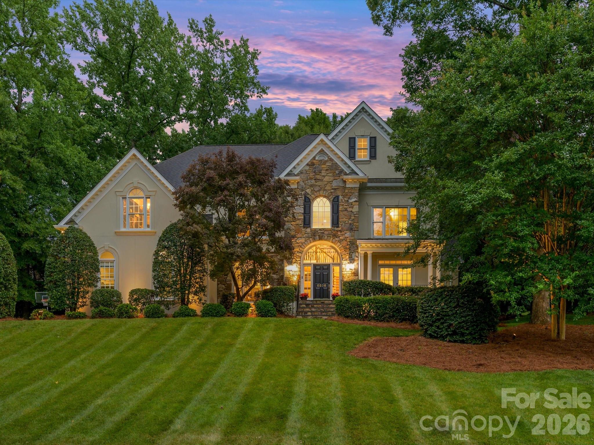 Exceptional Opportunity in Piper Glen!  This stately custom residence offers a dramatic yet highly functional floor plan designed for both elegant entertaining and comfortable everyday living. The impressive two-story Great Room with fireplace flows seamlessly into the chef's kitchen, featuring stainless steel appliances, a spacious breakfast bar, wine bar, walk-in pantry, and sun-filled bayed breakfast area. Begin your mornings on the expansive screened porch overlooking the private fenced backyard. Outdoor living is enhanced by a generous brick terrace, perfect for grilling, dining and relaxing with family and friends. The main level features formal dining, a private home office, and a versatile guest suite or bonus. Upstairs, the luxurious primary retreat showcases a fireplace, sitting area with soaring vaulted ceiling, abundant natural light, a customized walk-in closet, and a beautifully updated spa-inspired bath. Three additional bedrooms  compliments updated bathrooms, providing comfort and flexibility for family and guests alike. Additional highlights include hardwood flooring throughout the main level, a convenient drop zone, built-in garage storage, a large walk-in storage room, ample parking and exceptional storage solutions throughout. Ideally located near the McAlpine Greenway, Piper Glen & Stonecrest Shops, fine dining, Trader's Joes, and I-485, Private Memberships are available at TPC Piper Glen. This home offers the perfect combination of luxury, convenience and lifestyle. Meticulously maintained and move-in ready-- WELCOME HOME TO PIPER GLEN!
