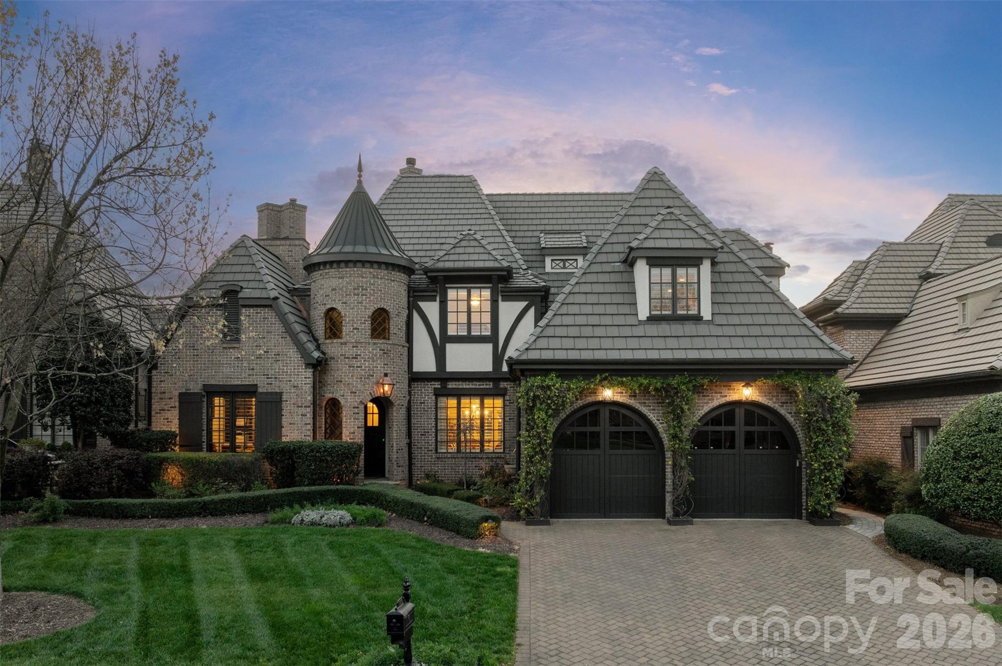 Set along the picturesque 17th fairway of Longview Country Club, this stunning English Tudor residence blends timeless charm with refined luxury and sweeping golf course views. Rich architectural details define the home, from coffered ceilings and custom millwork to cast stone fireplaces and thoughtfully designed built-ins.

The renovated chef’s kitchen is a true showpiece, featuring elegant quartz countertops, a designer backsplash, and updated lighting—all seamlessly open to the inviting family room, where expansive windows frame serene pond and fairway vistas.

A beautifully appointed office offers both sophistication and comfort, complete with a vaulted, beamed ceiling and a dramatic floor-to-ceiling stone fireplace. The highly sought-after main-level primary suite is a private retreat, offering direct patio access and tranquil golf course views. The spa-inspired bath features heated floors, a jacuzzi tub, separate shower, and a custom walk-in closet.

Upstairs, you’ll find three spacious secondary bedrooms, two full baths, and a versatile loft with built-ins. A generous bonus room opens through double doors to an upper balcony, where breathtaking panoramic views stretch across two fairways, the pond, and clubhouse. Additional storage is abundant with a large walk-in attic.

Perfectly positioned for both privacy and scenery, the home enjoys peaceful views front and back—the front overlooking a charming green space with gazebo. The two-car garage is enhanced with a lift for a third vehicle, built-in storage, and epoxy flooring.

Located within walking distance to the clubhouse, residents enjoy access to world-class amenities, including an 18-hole Jack Nicklaus signature golf course, dining, fitness center, pools, tennis, and a youth lodge. Lawn maintenance is included through the HOA, offering a truly low-maintenance lifestyle.