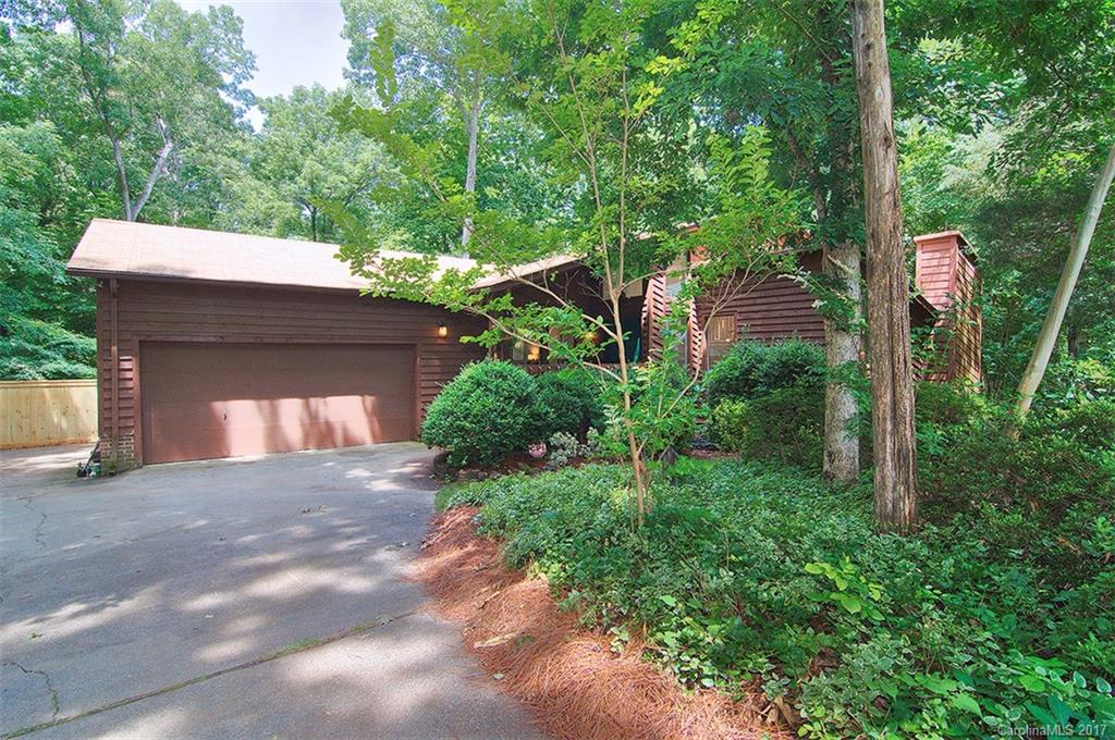 UNIQUE, contemporary split-level home right off Sardis Rd in beautifully established neighborhood.  This home sits on a cul-de-sac lot with tons of trees.  Master bedroom on main level and secondary bedrooms are upstairs.  On lower level is a 2-story great room with fireplace and hearth. Dining area has built-ins! Updated kitchen has waterfall quartz countertop and updated features throughout.  Kitchen is large with office area, ample cabinets and overlooks private and serene lot. LARGE lot!