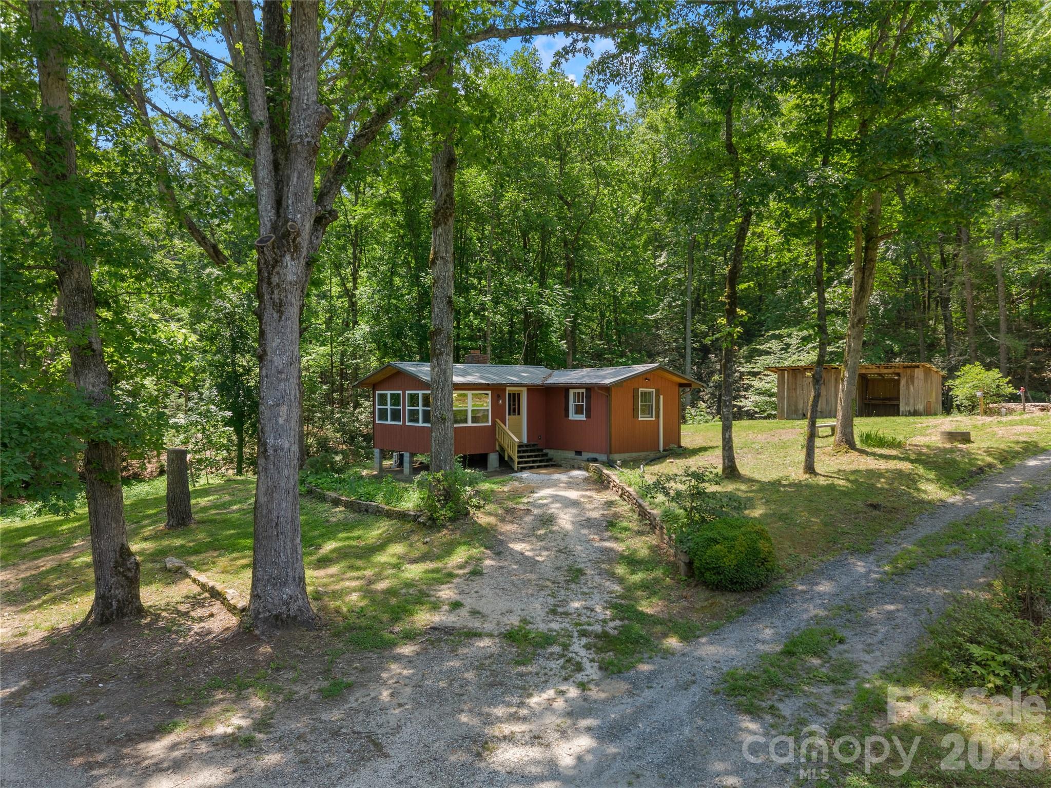 Completely renovated from the studs out, this cabin sits on 7.83 unrestricted acres in Mill Spring, where creeks border three sides of the property and long-range mountain views stretch beyond a landscape of pasture, hardwoods, and natural beauty. Every surface, finish, and system has been thoughtfully updated, creating a home that feels fresh, comfortable, and ready to enjoy from day one.

Outside, the property offers the kind of flexibility that's becoming increasingly difficult to find. A detached garage and additional outbuildings provide space for equipment, hobbies, storage, or animals, while the unrestricted acreage opens the door to countless possibilities.

A newly added RV hookup with septic connection allows you to comfortably live on the property while building, host guests, or create an additional basecamp for weekends in the mountains.

Whether you're seeking a private retreat, investment opportunity, small farm, or future homesite, the value here extends far beyond the cabin itself. Whether your vision is a mountain getaway, family compound, or custom home overlooking the water and mountains, this property offers the space, freedom, and infrastructure to bring it to life.