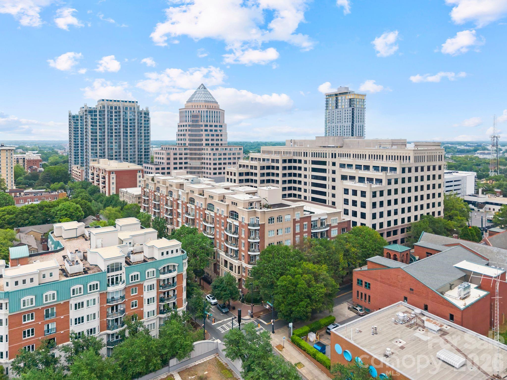 Rare opportunity to own one of the largest and most unique residences at 400 N Church Street in the heart of Uptown Charlotte. This beautifully reimagined 3-bedroom, 2.5-bath mid-rise condo offers a seamless blend of urban convenience and quiet, courtyard-facing serenity.

A truly special feature of this home is its dual access—enter via the secured parking deck and elevator, or enjoy the charm of a semi-private courtyard entrance that feels worlds away from the city. Step directly into your own front door from this peaceful setting, where the noise of Uptown fades and privacy takes center stage.

Inside, the home has been thoughtfully redesigned with a sophisticated, Restoration Hardware-inspired aesthetic. The open-concept living space is anchored by a stunning gas fireplace and flows effortlessly into a fully updated kitchen featuring a large, marble island ideal for entertaining, beverage bar, and top-of-the-line appliances.

The spacious layout offers exceptional flexibility, including a dedicated work-from-home option. One of the bedrooms has been transformed into an impressive walk-in closet with a custom California Closet system—truly a standout feature—while the other two expansive bedrooms include walk-in custom closets as well.

Positioned facing the interior courtyard, this unit offers a level of quiet rarely found in Uptown living—no road noise, just calm and comfort.

Additional highlights include one deeded parking space, an additional prepaid parking space through the year, and a deeded 5x8 storage unit.

The HOA covers water, sewer, trash, exterior maintenance, and access to a fitness facility, making for easy, low-maintenance living in an unbeatable location.

This is city living redefined—private, polished, and perfectly positioned.