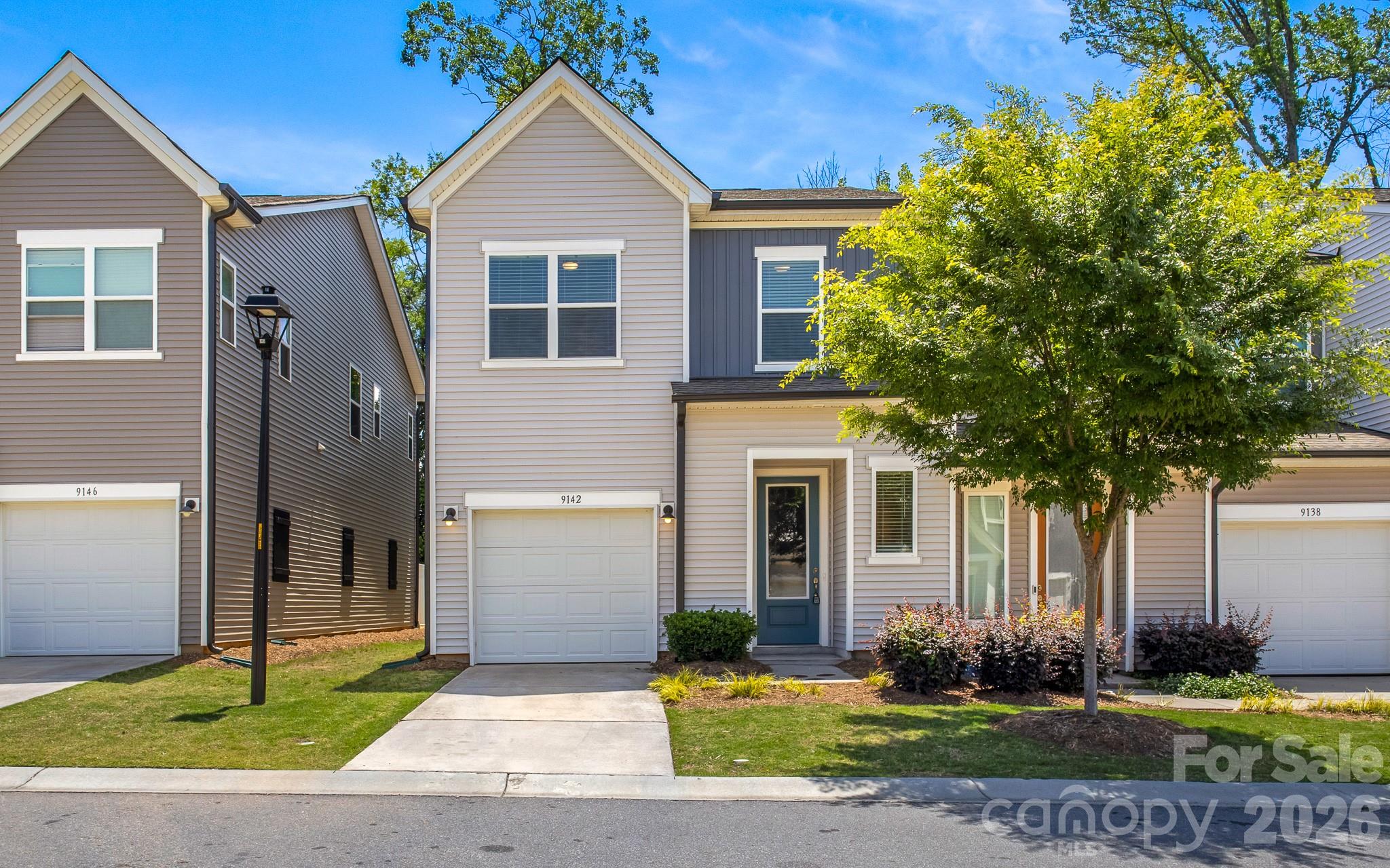 Introducing this move-in-ready end-unit townhome in the desirable Fifteen 15 Cannon community! Loaded with upgrades, this home offers modern style and a convenient location near NoDa, Uptown Charlotte, the University area, Charlotte Douglas Airport, and I-85. The open-concept main level features a spacious living area and a beautifully designed kitchen with Caledonia granite countertops, Benton Birch cabinetry, white tile backsplash, large island, electric range, dishwasher, disposal, and plenty of storage. A unique built-in dog area under the stairs adds charm and functionality for pet lovers. Enjoy seamless indoor-outdoor living with a 6-foot sliding glass door leading to the extended patio—perfect for relaxing or entertaining. Upstairs, you’ll find three bedrooms, including a spacious primary suite featuring a designer bath with tiled shower walls, tile pan, and built-in shower seat. The upper level also includes a convenient laundry room, two additional bedrooms, and a secondary full bath with dual vanity and tub surround. Complete with a one-car garage and access to nearby greenway trails, this beautifully maintained townhome combines comfort, convenience, and modern living in one exceptional package!