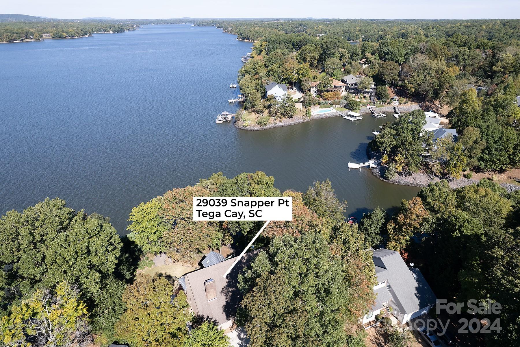 Gorgeous lakefront living awaits you.  Stunning home renovated 2016 offers incredible lakefront views, providing a picturesque backdrop for everyday living.  Extensive windows and doors flood the interior with an abundance of natural light showcasing hardwoods throughout.  Big on living space that includes a living room and parlor separated by a see through gas fireplace accented by lovely ship-lap walls.  Exit to the in ground gunite pool through a multi-purpose sun room. Spacious formal dining room with adjacent sunken sitting room provides tranquil lake views. The heart of the home is the kitchen with chef’s island, high end stainless steel appliances, including an exhaust hood that vents to the outside. There are quartz and granite counters, and custom cabinets. Located off the kitchen is a screened room that furnishes glorious sunsets. Upstairs houses the owner suite and three spacious bedrooms each with access to a full bath.