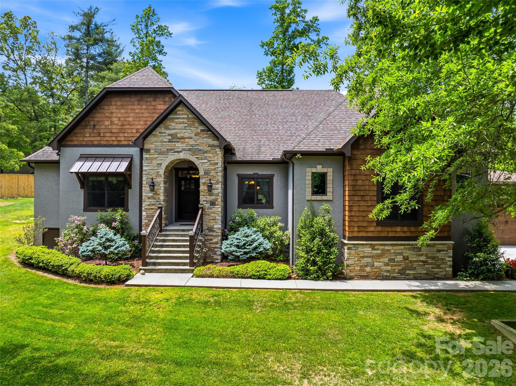 History Meets Modern Luxury: A Craftsman Masterpiece

Discover a home where every detail tells a story. This stunning 3-bedroom, 4-bathroom residence seamlessly blends high-end modern amenities with authentic historical character, offering a living experience that is as unique as it is luxurious.

Step inside to an open, airy floor plan accentuated by 9' ceilings and abundant natural light. The living room serves as a breathtaking centerpiece, featuring a stone fireplace with a mantle and ceiling beams reclaimed from an original 1805 log cabin. This rich history is balanced by contemporary sophistication in the kitchen, which features elegant, leathered granite countertops, a custom rustic wood range hood, and handcrafted white cabinetry made from trees harvested directly on the property. 

The primary suite is a true sanctuary of comfort. Organization is effortless in the large, walk-in closet with custom shelving and storage. The primary bath offers a touch of daily indulgence with heated floors, ensuring warmth and comfort throughout the year.

Car enthusiasts and hobbyists alike will marvel at the exceptional garage space. With two separate attached garages providing four parking spaces, the options are endless. Currently configured as a functioning pottery/artist studio and a traditional vehicle garage, these spaces feature soaring ceilings and ample power for any project. 

Situated on a beautifully manicured lot, the exterior is a masterclass in curb appeal with stone and cedar shake accents. The rear of the home opens to an expansive wooden patio overlooking a meticulously designed gravel garden and a charming detached shed. Whether you're hosting a summer BBQ or enjoying a quiet morning cup of coffee, this backyard is your private escape.

With tons of storage throughout - from oversized closets to the expansive garages - this home provides a place for everything and a space for everyone. Don't miss this impeccable blend of rustic and modern finishes.