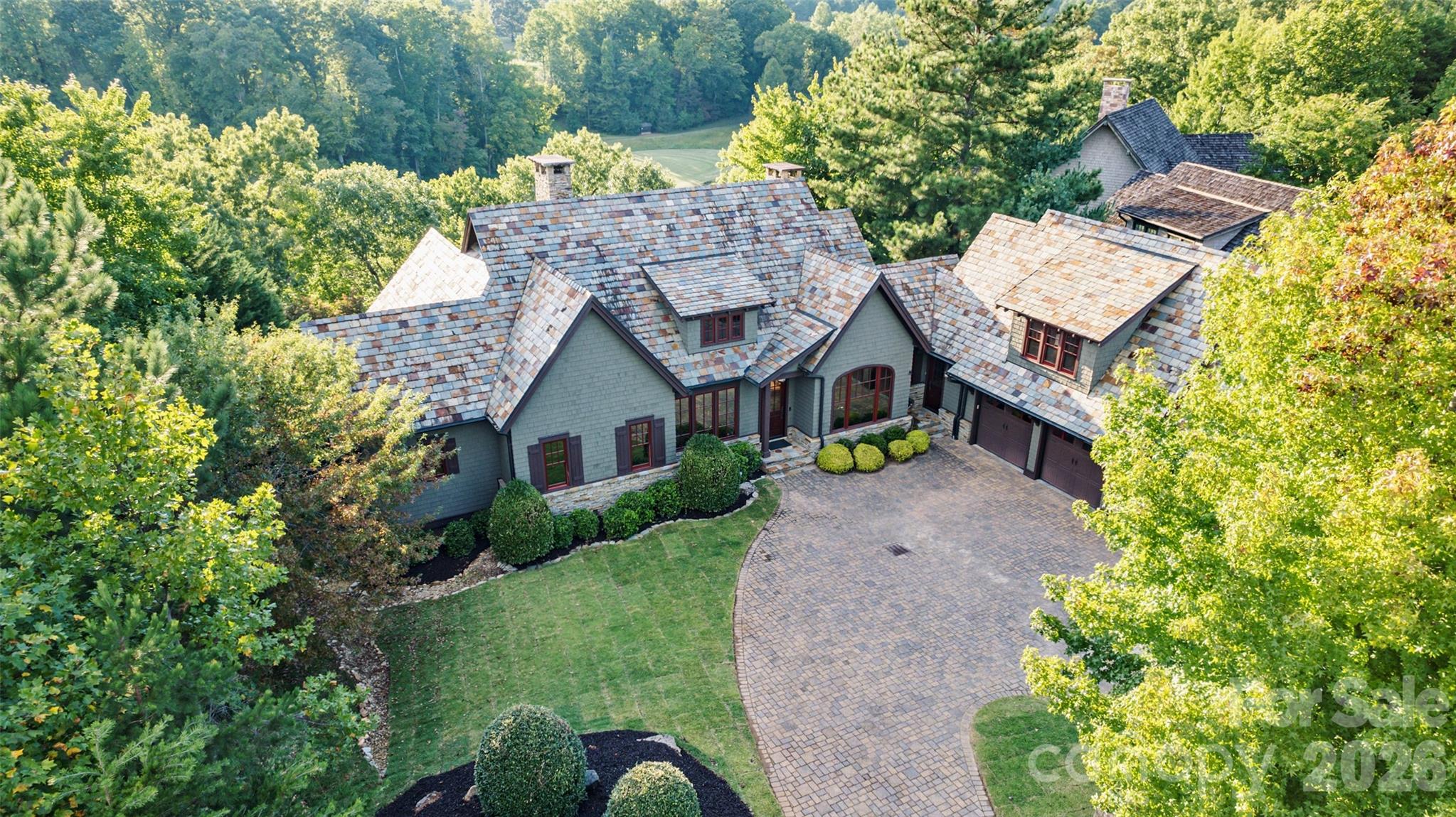 Arts & Crafts masterpiece, GrandView Lodge blends timeless beauty and modern luxury. Located in the Reserve section of Bright’s Creek. This custom-built home is awash in natural light and mountain views. It comes with 5 bedrooms, 5 ensuite baths and 2 half baths at approx 5,660 sq ft. This open floor plan boasts hickory trim, knotty alder interior doors, stone fireplaces, custom wall and ceiling finishes, Smart TVs with surround sound, elevator,  and 5 ensuite bedrooms. The master suite with towering ceiling and a ensuite spa-like bathroom, gourmet kitchen with river rock granite and top-of-the-line appliances (Wolf, Sub-Zero), exquisite dining room, large laundry room, porch has wood-burning fireplace. Outdoor entertaining space with kitchen. Guest suite above the garage. The bottom floor hosts a den, game room with a built-in wine fridge and sports bar. Unique POOL with a separate spacious hot tub. See documents for ALL the details and house plans.