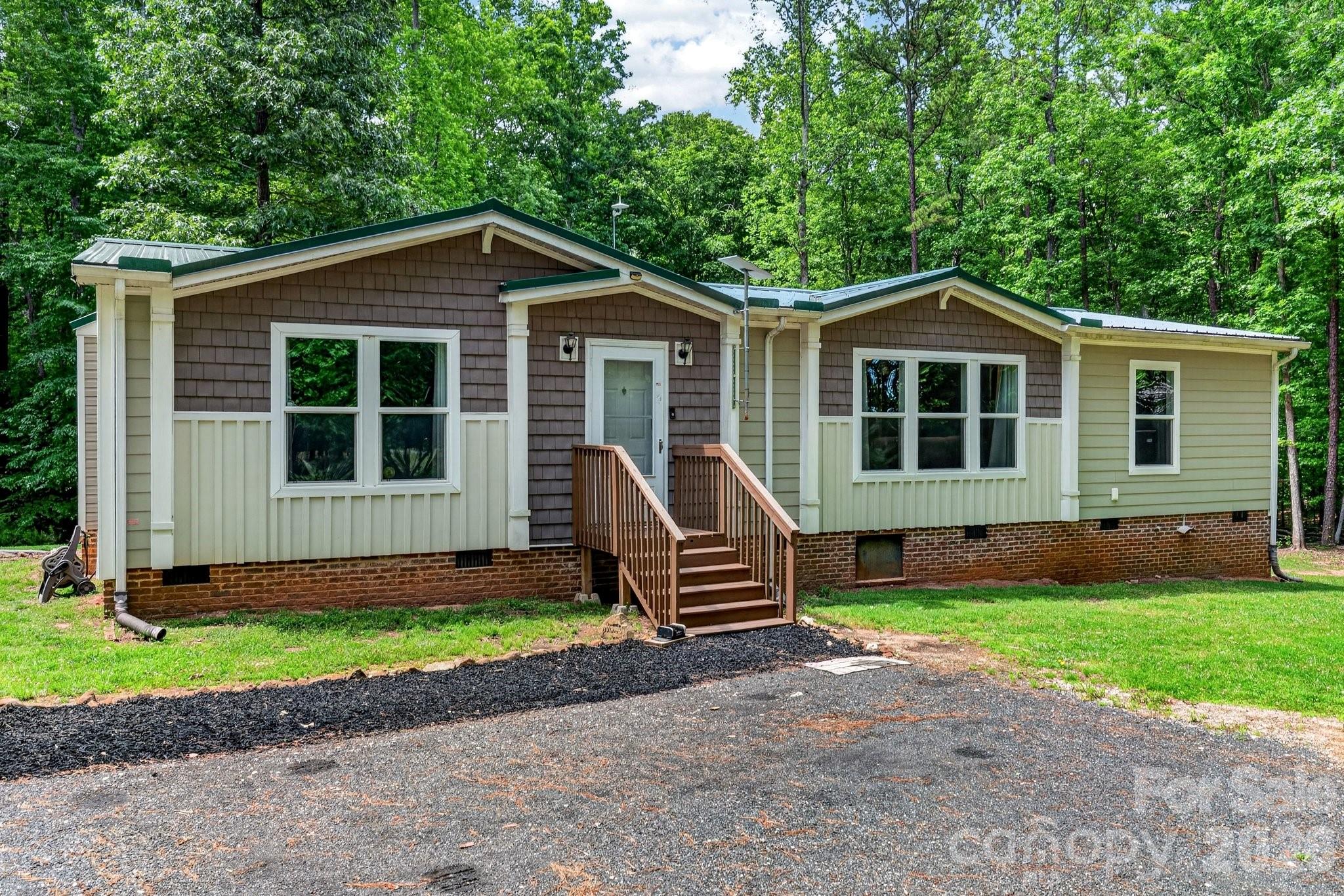 Craving space, privacy, and freedom from HOA restrictions? Welcome to your private retreat on 14 serene acres surrounded by mature hardwoods. Built in 2017, this charming 3-bedroom, 2-bath home offers a thoughtfully designed split floor plan with inviting, comfortable living spaces throughout. A recently added 30x35 detached garage/shop is wired and ready for your hobby or small business needs. Within the last two years, this home has received all new HVAC, flooring, kitchen appliances, paved driveway, and structural improvements. The heart of the home is a spacious eat-in kitchen featuring a center island, pantry with a stylish sliding barn door, and plenty of room to gather. An oversized laundry and craft room adds extra flexibility for hobbies, storage, or workspace needs. The owner’s suite is a true escape—bright and airy with soft neutral tones, a spa-inspired bathroom complete with an oversized tiled shower, and a separate soaking tub perfect for unwinding. Step outside and take in the peaceful surroundings from the large deck with included patio set—ideal for relaxing or entertaining while overlooking your own private sanctuary. A durable raised-seam metal roof was installed in 2022 for added peace of mind.