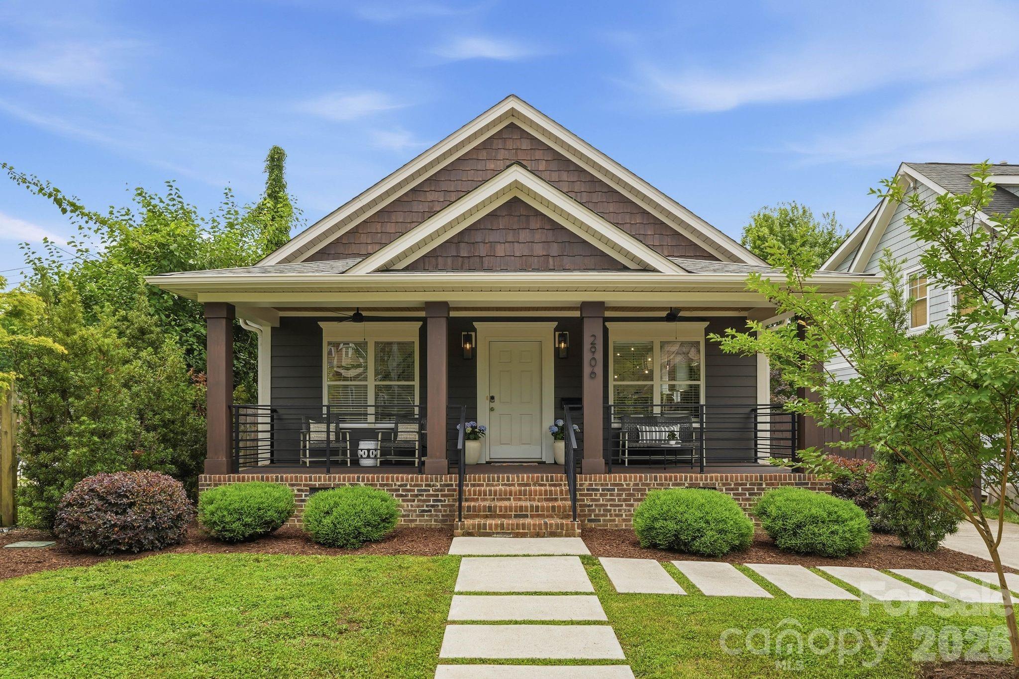 Welcome home to this charming Midwood bungalow offering the perfect blend of comfort and style in the heart of Charlotte. This spacious 1,667-square-foot residence was fully updated in 2021 and boasts 3 bedrooms and 2 bathrooms, thoughtfully designed for modern living. Step inside to discover a warm and inviting atmosphere, complete with beautiful hardwood floors and a light filled open floor plan. The centerpiece of the home is the chef’s kitchen, featuring a massive island with prep sink, large double sink overlooking the side yard, a commercial grade gas stove, refrigerator, dishwasher, and plenty of space for culinary creations. Adjacent to the kitchen is a welcoming living area, perfect for relaxing by the fireplace. The primary suite offers a serene ensuite bathroom with a double sink vanity and walk-in closet. Upstairs, a dedicated media/recreation room provides flexible space to meet your lifestyle needs. Step outside to enjoy the outdoor features, including a welcoming front porch, rear deck off the primary suite, and fenced backyard, ideal for entertaining or unwinding in privacy. New roof in March 2026, HVAC and water heater in 2021 provide peace of mind.