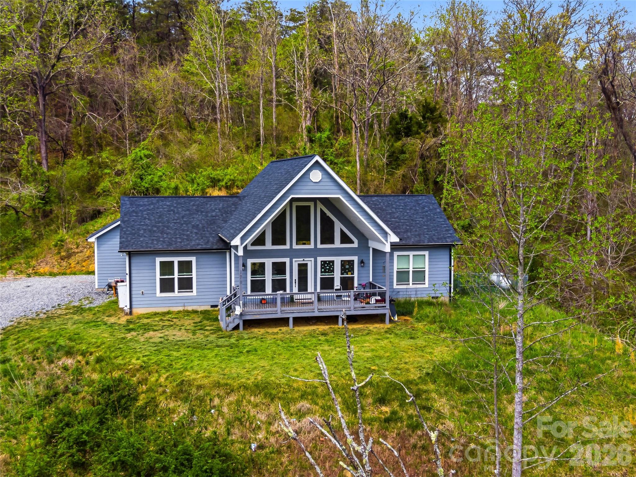 Motivated! Welcome to beautiful mountain views with newer home built in 2021 on 6.35 acres @ Starry Night! Open living, kitchen & dining areas let you take in the airy views. Perched on an open knoll with long range views to the south & west. This small community of Redmon Ridge has light restrictions in place. Home has a large covered porch for stargazing or utilize the back porch for grilling & more entertaining. All one level living, sets this home up for ease of access. The home has been pre-wired for a generator. HVAC is electric with propane back up for efficiency. The living/dining/kitchen area separates the primary bedroom from the 2 bedrooms & a full bath. The primary bedroom has an en suite bath and closet, with large soaking tub. 

Located right above put-in at Redmon Damm for the river enthusiasts. Which allows public access to rafting, canoeing, fishing, etc. Convenient 5 minutes to the Town of Marshall NC or.. 30+/- mins to City of Asheville.
