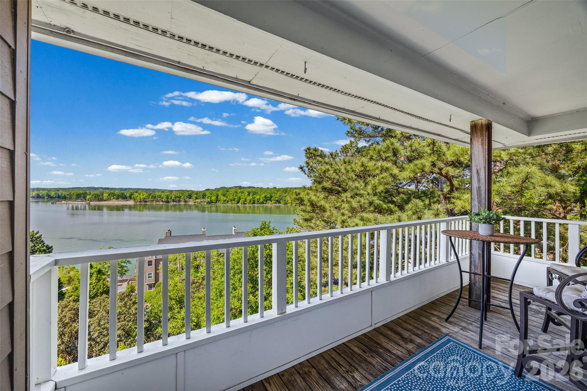 Overlooking picturesque Lake Wylie, this stunning end-unit waterfront condo with deeded boat slip, will take your breath away! From the moment you arrive, the open and bright floor plan draws your eye to the vast water views, which can be enjoyed from all the main areas of the home, as well as the primary bedroom and bathroom. As you enter onto the vinyl plank flooring that runs through the common areas, you are greeted by a cozy drop zone area and updated kitchen. This kitchen boasts a new dishwasher (May 2026), quartz counters, white cabinetry, a deep stainless steel sink, ample counter space, stainless steel appliances, and a wet bar area with beverage refrigerator and sink. The expansive dining area is the perfect place to enjoy meals with the lake as your backdrop. Heading into the great room, you'll find details such as a stone fireplace, built-in shelves and cabinets for storage, and ceiling details to draw your eye up. The highlight of the home awaits on your private covered balcony, with expansive views of Lake Wylie and the most stunning spot for sunsets! You'll also find an outdoor storage area for extra space. Back inside, the primary bedroom offers an impressive size, and has it's own access door to the balcony as well. Whether in bed or from the bathroom, you can find views of the lake all around you. The primary bathroom features dual sinks, updated vanity and mirrors, a walk-in shower and separate garden tub, and large walk-in closet space. Storage abounds with a laundry area with charming barn doors with extra storage. The secondary bedroom is a spacious size, and another full bathroom round out the floor plan. Also included are the refrigerator, washer, and dryer. You can head on down to the community dock, where boat slip #62 is deeded with this home, and comes with the unique feature of it's own boat lift! The community amenities take full advantage of the resort style living, with an outdoor pool and sidewalks throughout. Water and a termite bond are included in the HOA dues. Emerald Point is conveniently located close to the Charlotte Douglas International Airport, and has easy access to I-485 and I-77, and nearby local amenities such as the Charlotte Premium Outlets, excellent restaurants, and tons of shopping. Welcome to your perfect resort living home!