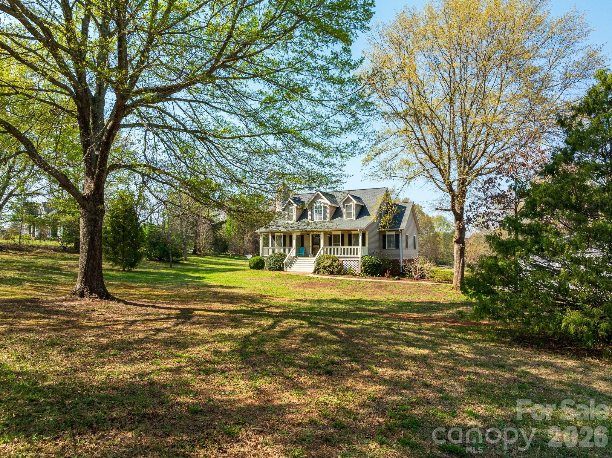Set on 4.38 picturesque acres, this classic Cape Cod–style home offers the ease and beauty of country living with wonderful equestrian potential. The 3BR/2.5BA main residence features new flooring in multiple rooms and a warm, welcoming feel, with outdoor living spaces that invite you to slow down and take in the land—an inviting covered front porch, rear deck, and lower patio overlooking the grounds. A thoughtfully designed basement apartment provides added versatility with a private 1BR/1BA, kitchen, and family room—ideal for guests, extended family, or caretakers. The property lends itself naturally to a mini-farm or horse setup, featuring a barn with hay storage and four run-in bays, along with an electric fence that may remain or be removed to suit your vision. A newly constructed 40x50 three-bay garage/workshop offers ample room for equipment, trailers, and weekend projects. With open space to roam, ride, and breathe, this special property blends timeless Cape Cod charm with the freedom of an equestrian-friendly setting—an ideal retreat for those seeking a quieter, more grounded way of living.