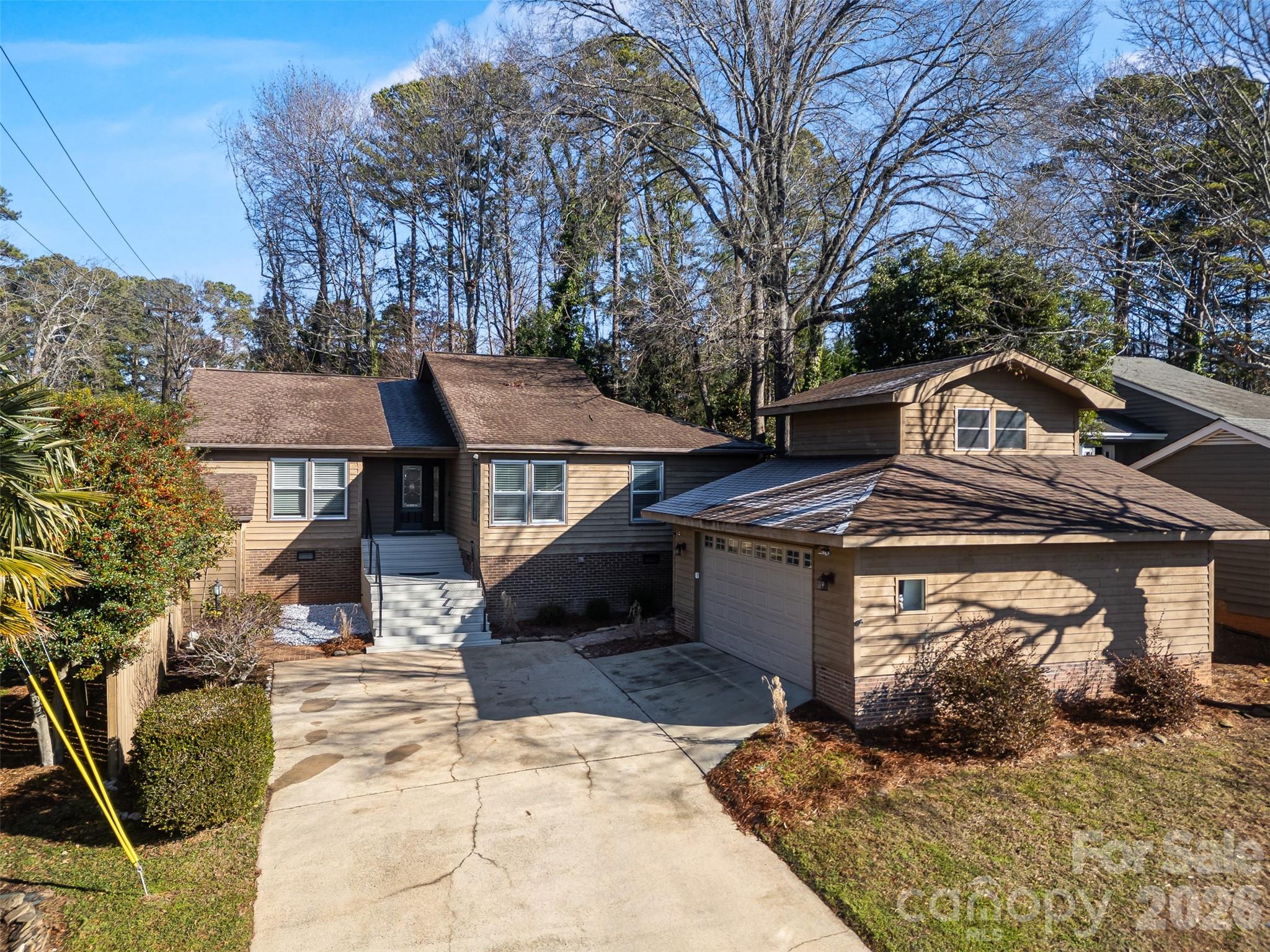 20 Quayside Court in desirable River Hills is more than just the house - although the house is pretty great!  This beautifully updated ranch offers modern living with thoughtfully designed split-bedroom floor plan. Fresh paint, new lighting throughout, and updated bathrooms give the home a crisp, move-in-ready feel. The large living room is anchored by a beautiful gas fireplace flanked by new sliding doors to the private deck.  The open floor plan is great for entertaining and generous living spaces make everyday living comfortable and easy.  Kitchen with large island opens to all seasons room and private yard.  A detached oversized garage is a standout feature, complete with epoxy floors, workshop & storage space, PLUS 200+sf heated/cooled space above that’s perfect for a home office, man cave, she-shed, studio, or flex space to fit your lifestyle.  From spontaneous pickleball games just across the street to music trivia at the club on Wednesdays, life here is built around connection and fun. Spring arrives early when you’re closing in time for tee season on the award-winning 18-hole golf course. Evenings often mean hopping in the golf cart to a neighbor’s for cocktails or heading down to the marina for dinner by boat.  "Come Home to a Resort Every Day."  That's the River Hills way and 20 Quayside Ct is your ticket in.