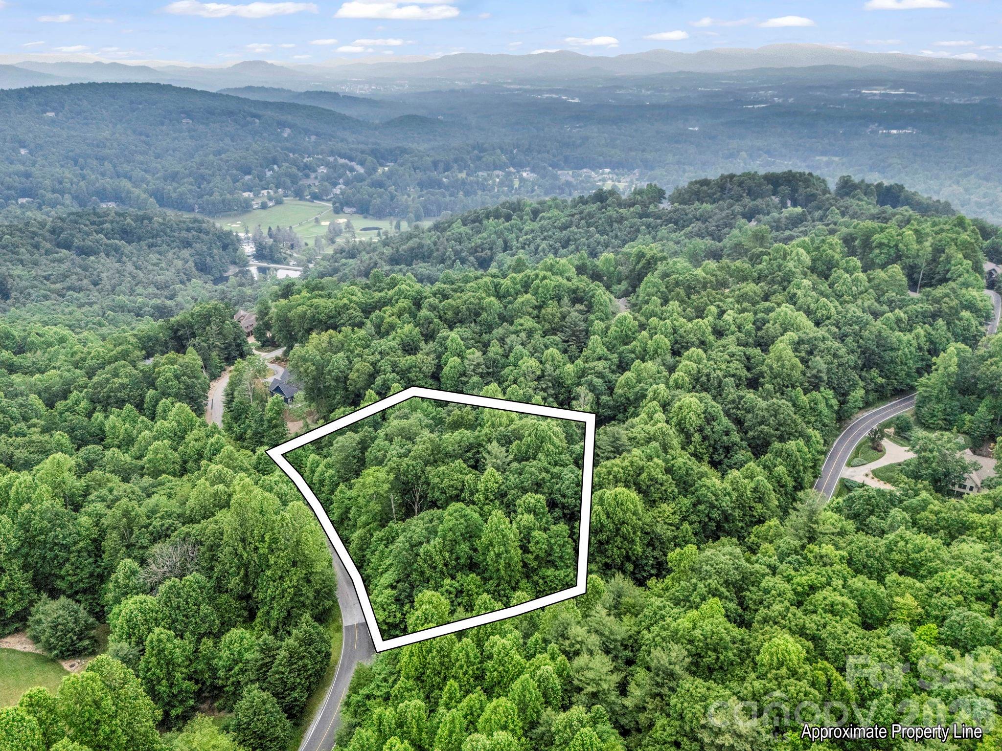 Fantastic oversized 2-acre corner lot to build your dream home in the historic and highly desirable Kenmure development! City water, underground utilities, natural gas and fiber available. 2 very buildable acres with little elevation change conveniently close to the front of the neighborhood! Near the gate, clubhouse, and amenities. This lot contains a number of mature hardwood trees and a small seasonal stream as well as possible winter mountain views depending on build site! Kenmure amenities include golf, tennis, pickleball, bocce courts, as well as a fitness center with top-rated equipment, a heated outdoor pool, and a saltwater indoor pool. Reasonable association fees cover road maintenance and security. Additional membership packages available for dining, fitness and golf. Kenmure is conveniently located in historic Flat Rock and very close to downtown Hendersonville. Don't miss out on this property as this location in the upscale Kenmure doesn't come on the market often!