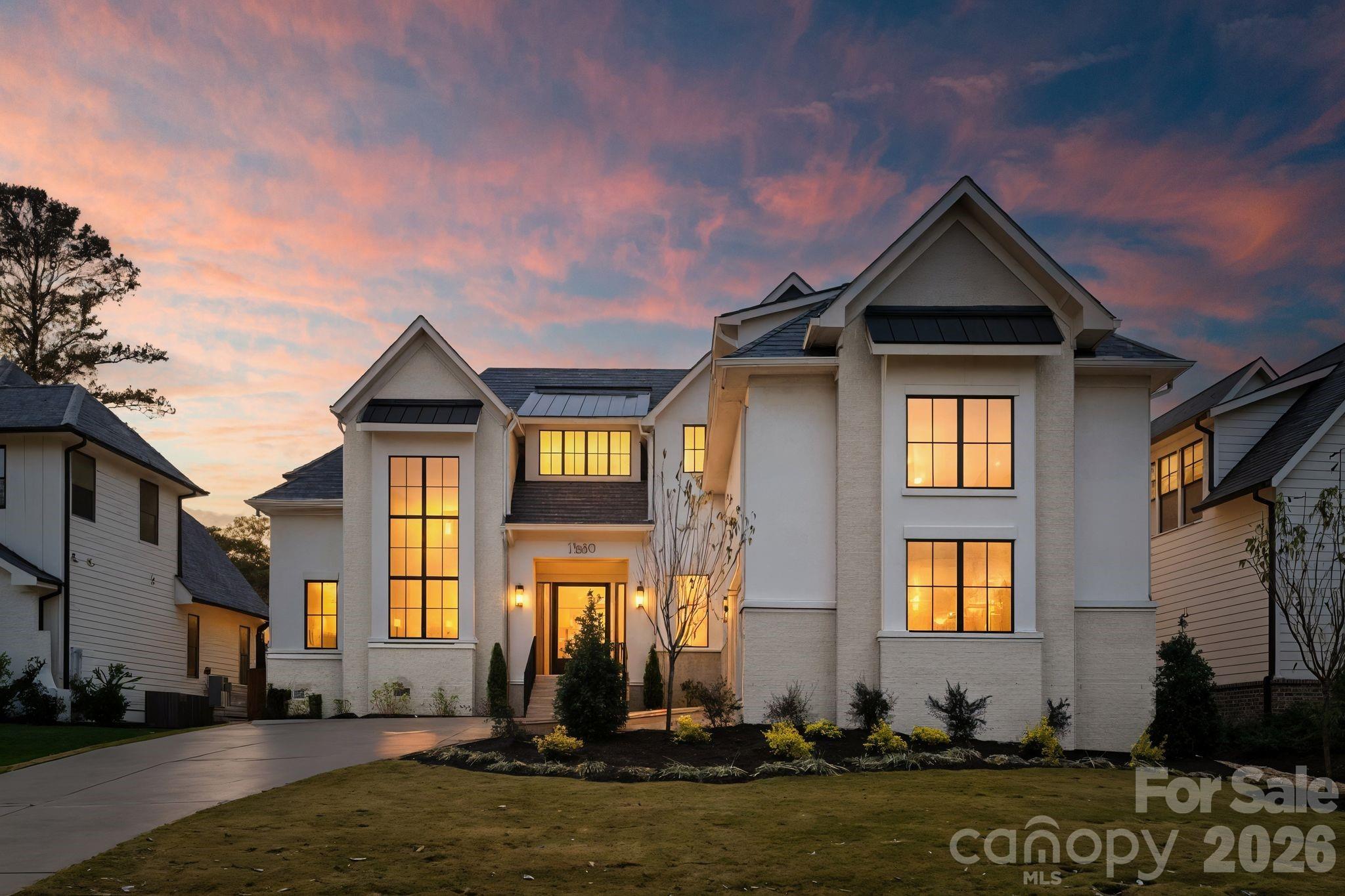 Welcome to Keen Building Company’s 5,036 square-foot luxury new build in the sought after Sedgefield neighborhood. The front elevation of this home features full masonry construction, an oversized modern steel-frame pivot door, a custom wood garage door, a landscaped courtyard driveway and a dramatic glass tower of windows showcasing the floating staircase and oversized chandelier. The outdoor living area includes a spacious covered porch with a fireplace and an uncovered porch with a built-in grilling station. Inside, the impressive two-story foyer with its floating staircase creates a grand entrance filled with natural light and an open, airy feel. This home offers five bedrooms including two primary suites (one on the main level and one upstairs) and five and a half bathrooms. The kitchen features a high end paneled appliance package, a large island, and a walk through scullery with an expansive secondary appliance setup, functioning as a secondary kitchen. Additional highlights include a large flex/game room with a TV entertainment area, dining space, and wet bar. The home also includes an advanced tech package with a built-in Sonos premium speaker system, Eero Pro access points, and a Ubiquiti G5 camera system. Habersham Drive is a quiet, prestigious street and the only one in Sedgefield with a tree-lined median. This is your opportunity to live on one of the neighborhood’s most desirable streets in a thoughtfully designed luxury home featuring exceptional craftsmanship and elevated finishes throughout.
