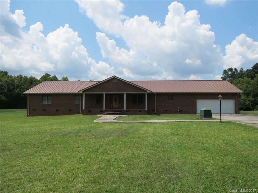 Large brick home on 15 acres in Rock Hill.  The home is very open and has large hallways and large rooms.  The kitchen is very open with plenty of counter space and even more cabinet space.  There is a large attached garage and also a large detached shop/garage.  There is a large wooded area in the back of the property that goes back to a large creek.  Back yard has grape vines and pecan trees and is very private.