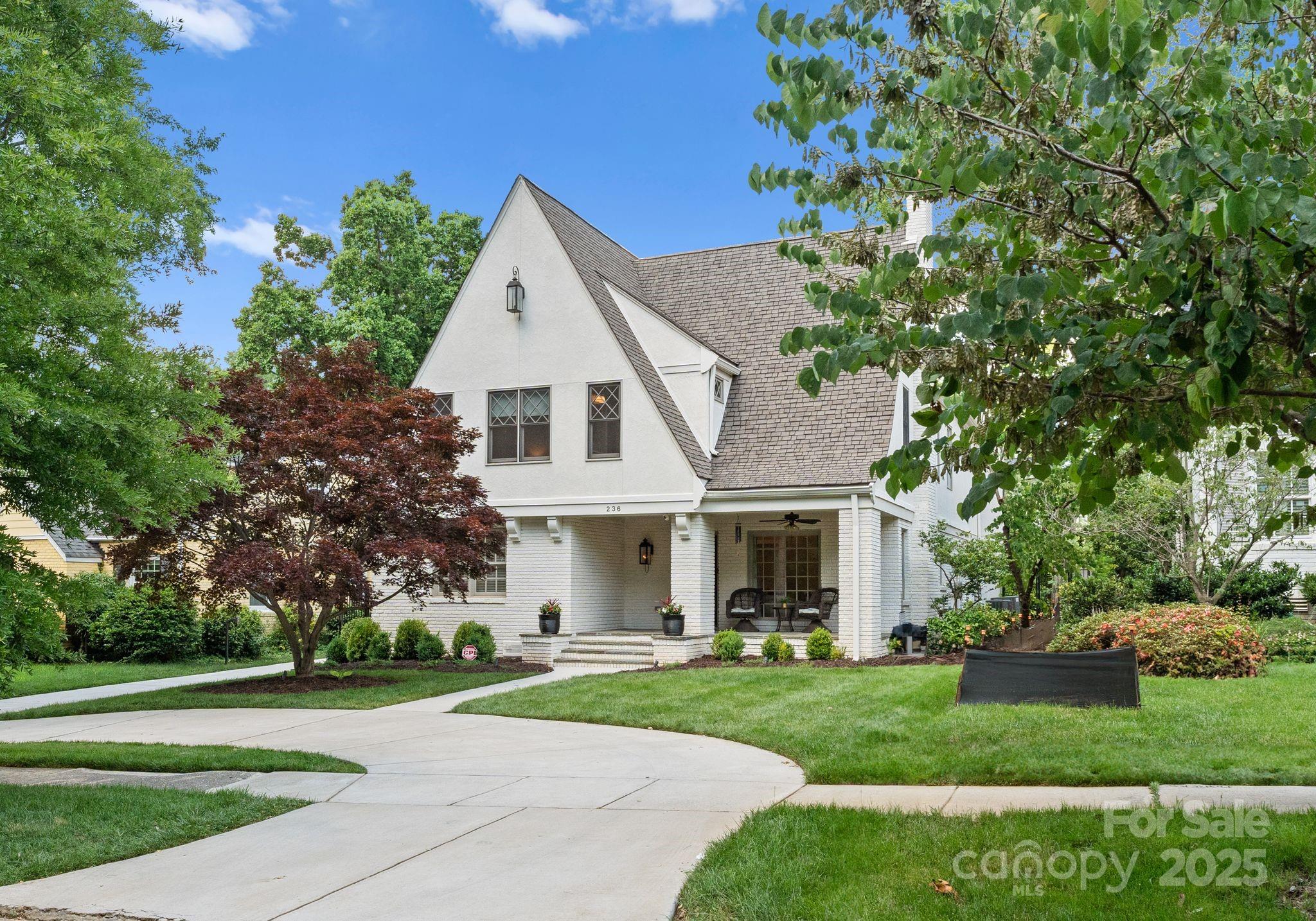 Gorgeous traditional family bungalow nestled in the heart of Myers Park. Welcoming blue stone rocking chair front porch. 2 primary suites on main & upper level. Main level features a formal living, dining w/french doors, bar area w/ ice maker, wine fridge & quartz counters. Chef's Kitchen w/eat in island, range/hood, pantry, & breakfast area. Opens to bright Family room with high ceilings, large window, customs built-ins, & gas FP. Designated drop zone w/custom cabinets & half bath. Primary on main has dual vanities & soaking tub. Patio, private fenced yard with plenty of play space, blue stone fire pit, irrigation & outdoor lighting. Upper level w/ loft, office, laundry, 2nd primary w/ 2 marble vanities, walk in shower, & walk in closet. 3 additional bedrooms & 2 full updated baths. 2 car detached garage w/guest suite, full bath, quartz counters, wine fridge, ice maker. Circular drive w/electric gate w/code access. Amazing location between Selwyn Ave & Park Rd Shopping center.