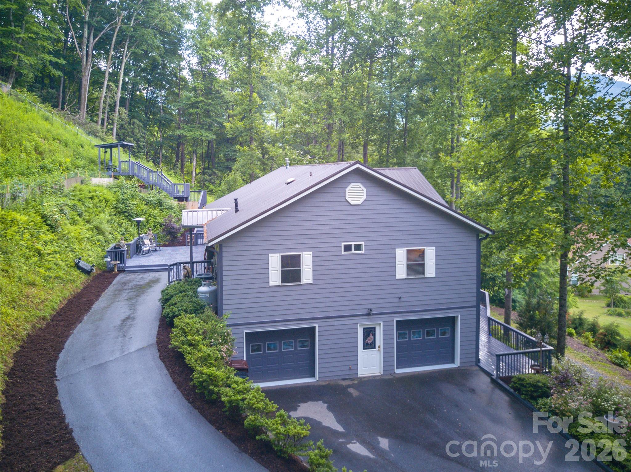 This stunning, fully remodeled estate is where luxury meets income potential! Boasting 9' ceilings, dual driveways with zero-step entry on both levels, dual kitchens, and dual laundry, this home was thoughtfully redesigned for style, comfort, and flexibility.
Enjoy the indoor sauna and jacuzzi, plus a vast amount of outdoor decking surrounding the home perfect for entertaining or relaxing in private luxury.
This home is close to all things in the heart Maggie Valley and yet private seclusion easily accessible.
The mother-in-law suite includes its own new kitchen and is currently a vacation rental. Lower has 2 rooms.. Keyless entry throughout..! Main level has 3 rooms and an office.
*Primary on main level
*Primary Suite on lower level
*Butler Pantry
*Leathered granite and marble in Kitchen and Laundry
*Marble and quartzite in baths
*Custom Cabinetry
*2 Stone Fire Place
*2 additional lots

Current owner is a high-end GC with a meticulous 3-year remodel—no detail 
overlooked!

MUST SEE. Bring all pre-qualified buyers!