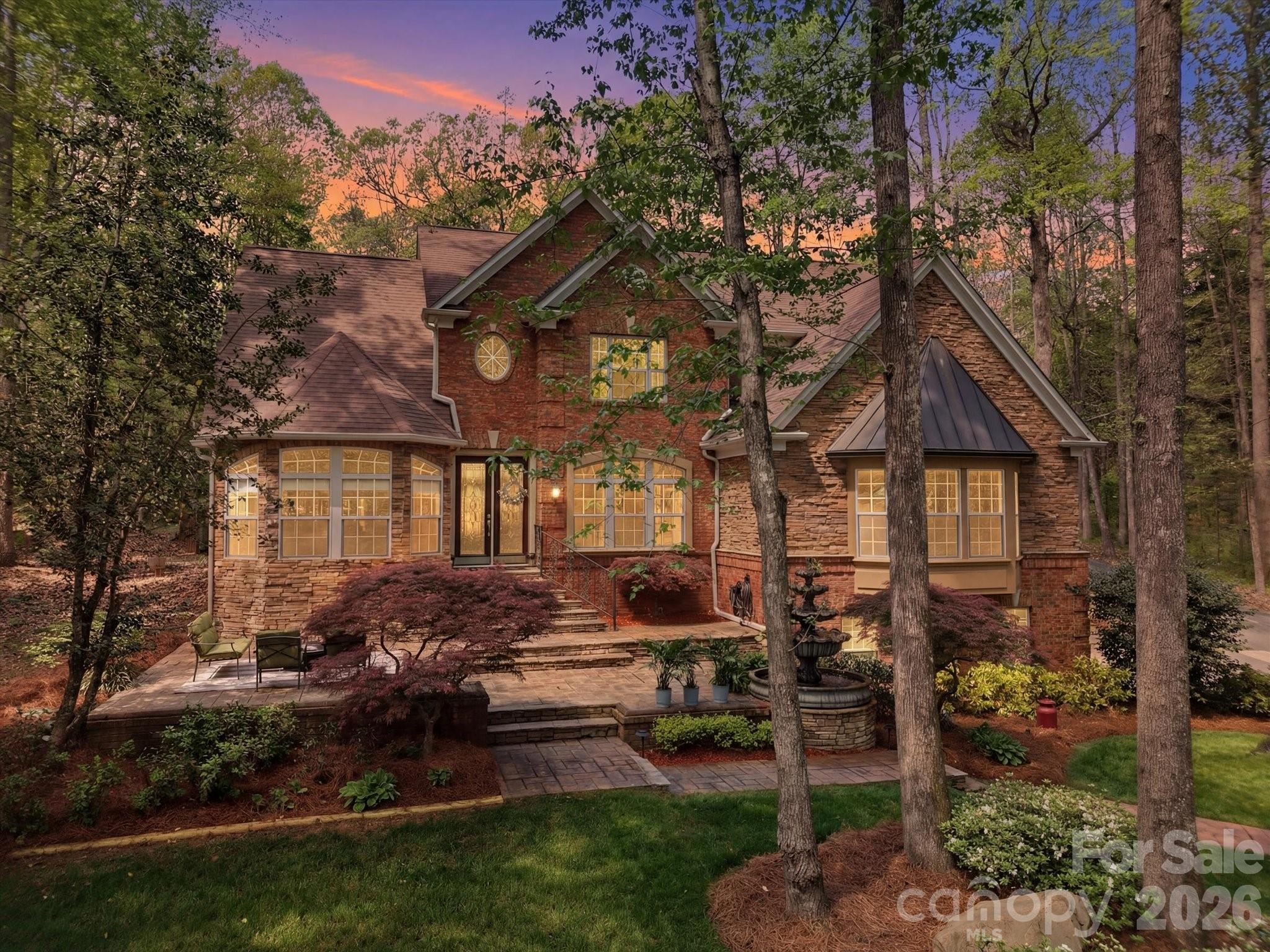 Private, full brick custom home on 1+ acre with detached garage/workshop and room for a pool and zoned for top rated Fort Mill schools, this is the one you have been waiting for! Set back from the street and surrounded by mature trees and established landscaping, this property delivers a true sense of privacy and seclusion. Inside, a two story foyer opens to a spacious dining room with butler’s pantry. The main living area features expansive ceilings and a double sided gas fireplace connecting the great room and kitchen. The updated kitchen (2026) features quartz counters and backsplash, new gas cooktop, updated lighting, and a large island plus a breakfast area and additional sitting/morning room overlooking the backyard. A second oversized living space with built-ins offers flexibility for media, recreation, or gathering. The primary suite on the main level provides convenience and complete with a renovated bath (2024) featuring quartz counters, a large walk-in shower, garden tub, and a spacious walk-in closet.  Upstairs, you’ll find four additional bedrooms, including a guest suite with private bath, plus a flexible room currently used as an office that has closets and could be used as 5th BR/bonus room. One of the most unique features of this property is the detached 1,073 sq ft garage/workshop, complete with 200 amp service, heat pump, built-in cabinetry, and storage ...ideal for a workshop, home business, car enthusiast, or future guest suite/multigenerational living potential. This home has fresh paint and beautiful trim work throughout, they don't make homes like this anymore! There is plenty of room to add a pool and you are zoned for Dobys Bridge Elementary, Forest Creek Middle and Catawba Ridge High School. New Harris Teeter shopping center is minutes away and you are just ten minutes from Publix, Target, Costco, Homegoods and so much more retail and restaurants!