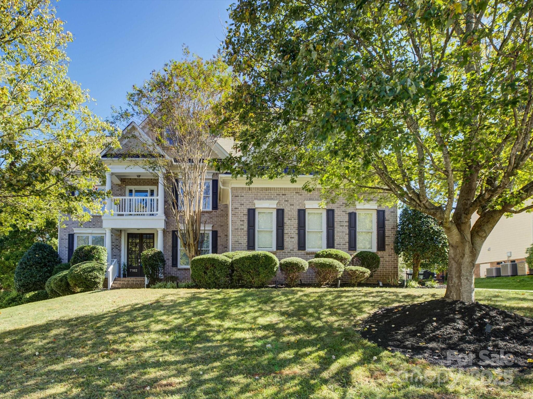 Experience Carolina living at its best in the heart of Bridgemill—one of the area’s most sought-after communities, known for its award-winning schools, vibrant neighborhood activities, and resort-style amenities. Residents enjoy access to a stunning clubhouse, dog park, fitness center, tennis and game courts, playgrounds, pond, outdoor pool, and endless sidewalks that invite evening strolls. This stately 4,200+ sq ft brick executive home spans three impressive levels and offers space, comfort, and sophistication. The main level features a private home office with French doors, a guest suite with full bath, and a two-story great room with a fireplace framed by custom built-ins and floor-to-ceiling windows. The kitchen opens to a sunny breakfast area and a cozy keeping room with its own fireplace. Upstairs, four additional bedrooms include an exceptional primary suite with tray ceilings, a luxurious bath, and an oversized adjacent room ideal for a gym, reading nook, or second office. The third floor provides the perfect recreation or media room. Also enjoy the private, tree-lined backyard, complemented by a 3-car garage, hardwood floors on the main level, and brand-new carpet on the upper level.