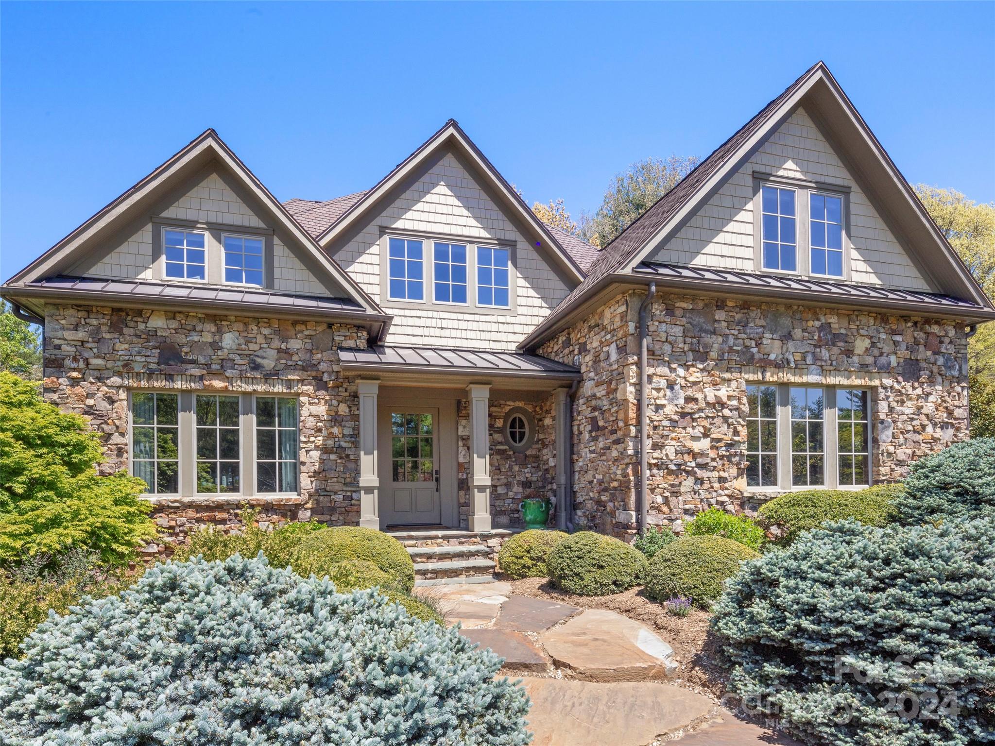 Located in the Ashbrook Meadows community in picturesque Cane Creek Valley just down the road from the well-known Taylor Longhorn Ranch and a few short miles to Biltmore Park and only fifteen miles to downtown Asheville. This property boasts lovely pastoral, wooded and mountain views on over 4.5 acres. Recent extensive renovations offer elegant spaces throughout that highlight the best of Southern country living. Soaring ceilings, gorgeous wall coverings, rich drapery, dual primary baths and closets, and a fabulous terrace level ready for family fun. Attractive bedroom suites are all set for family and guests. Mature trees and gently rolling vistas beckon from the covered porches. Property backs up to 3.7 acres of dedicated green space for extra privacy. An additional two-car carriage house-style separate garage with workshop space and unfinished second level makes an ideal pied-à-terre or separate home office space. Enjoy the community pavilion, natural stream, and horse riding ring