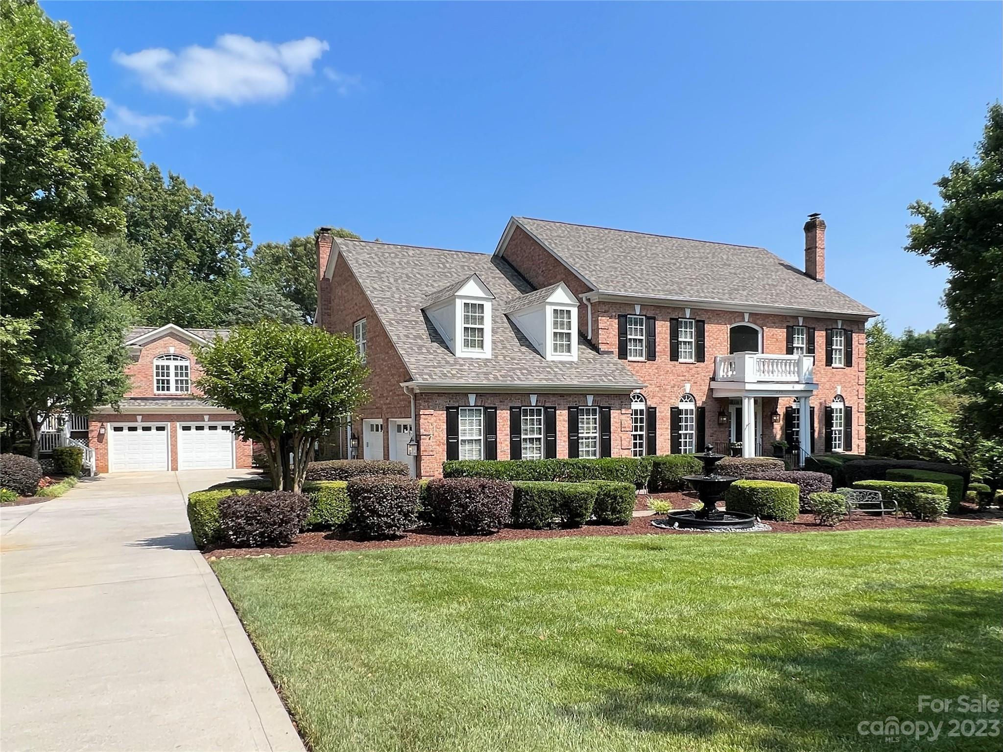 Spectacular Davidson estate walking distance to Main St. This sun-filled brick home truly has it all; 5 bedrooms across 3 levels in the main house, 2 car attached + 2 car detached garage w/studio apartment above offers kitchen & full bath for in law/au pair/studio space. This private 1+ac oasis has mature landscaping, expansive pool & spa area w/gas fire pit just steps from the walk out basement, which features billiards area, entertainment space, wet bar, laundry rm & guest en suite. The main level features formal living & dining rooms, office, family room & gourmet kitchen w/keeping room adjacent to oversized covered patio leading to the backyard & pool area. The 750sf primary suite boasts vaulted ceilings, sitting area, walk-in custom closets & spa-like bath. 3 add’l BRs, 2 bathrooms & 2nd laundry complete the upper level.  4 fireplaces lend warmth & character to the home. Located near entry to the Greenway & just 1 mile from Davidson College, this truly is an extraodinary property