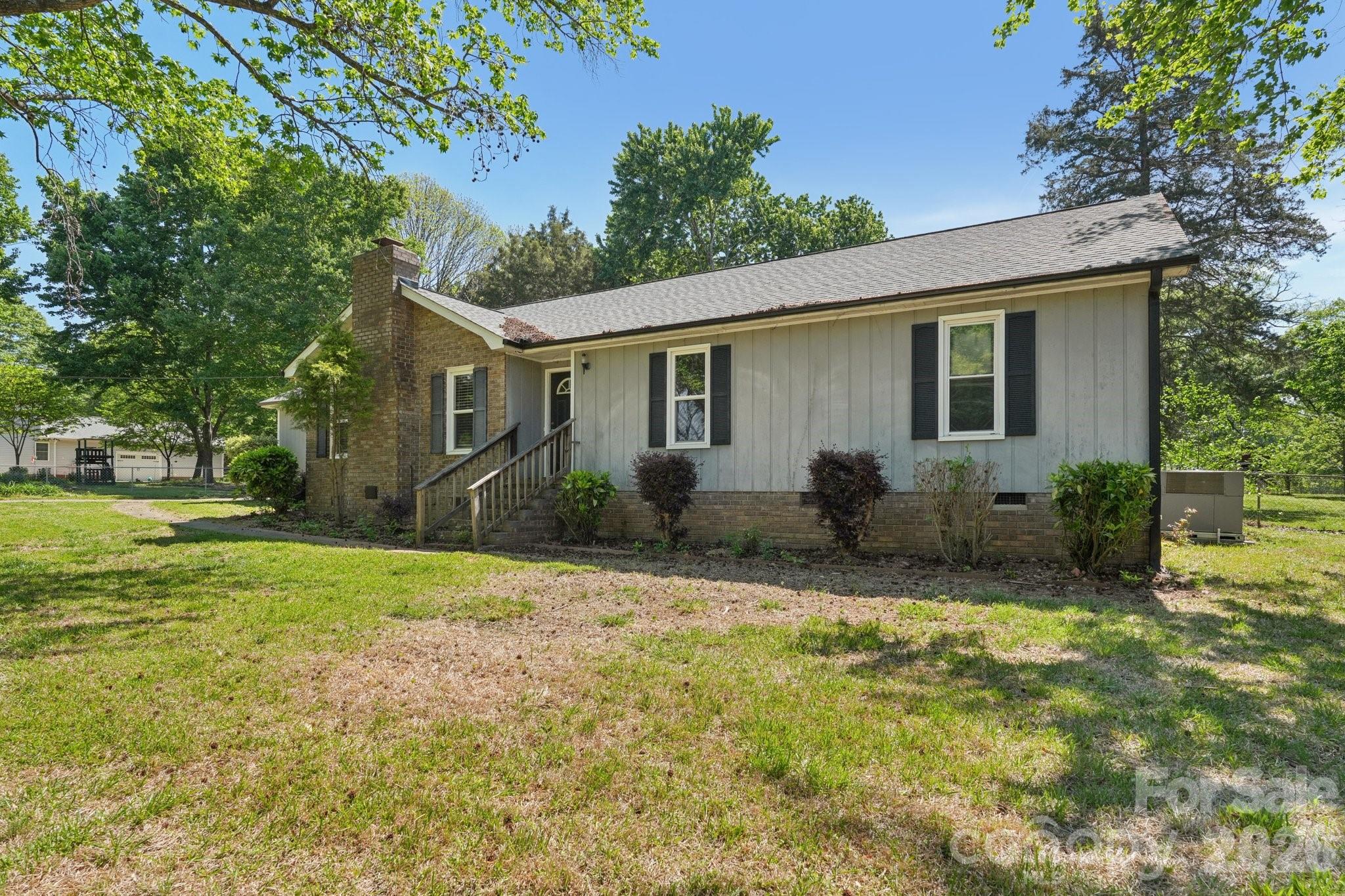 Welcome to Robin Lane in Rock Hill, SC, where space, flexibility, and no HOA come together on over an acre of land. This 4-bedroom, 3-bath home offers a unique setup with separate living quarters, making it ideal for multi-generational living, extended guests, or potential rental income.

The home features a roof that is approximately 2 years old, providing peace of mind for the next owner. Solar panels are fully paid off, allowing you to enjoy energy efficiency without an additional monthly payment. A 2-car carport and detached garage/workshop offer ample space for parking, storage, hobbies, or projects.

The expansive lot provides plenty of room for outdoor activities, gardening, or simply enjoying the privacy and space that comes with over an acre. A chicken coop is already in place for those interested in a small hobby farm setup or fresh eggs at home.

The property offers a great opportunity for a buyer to bring their own style and updates. With a solid structure already in place, this home is ready for someone to add personal style and make it their own.

If you’ve been searching for a property with land, versatility, and long-term potential, this one is worth a closer look.