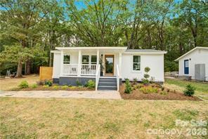 Welcome to this cute 2-bedroom, 1 bath home in thriving York. A welcoming covered front porch will be your cozy space for summer and sweet tea. Beautiful luxury plank flooring, newer windows that provide tons of natural throughout, and an open concept floorplan awaits. Quartz countertops, white tile backsplash, neutral-tone cabinetry and recessed lighting along with stainless steel appliances provide a gourmet feel in this kitchen! Newer roof, HVAC, water heater and washer/dryer space with custom shelving for storage. Renovated bathroom features a tiled tub/shower combo, new vanity, new toilet and hexagon tile flooring. Home sits on .38 Acre with nice deck outback to soak up the sunshine. Great location close to historic downtown York, shops, dining and York Recreation Complex along with nearby Rock Hill (15-minute drive) and Charlotte (30 mins). Take a look at this one today.