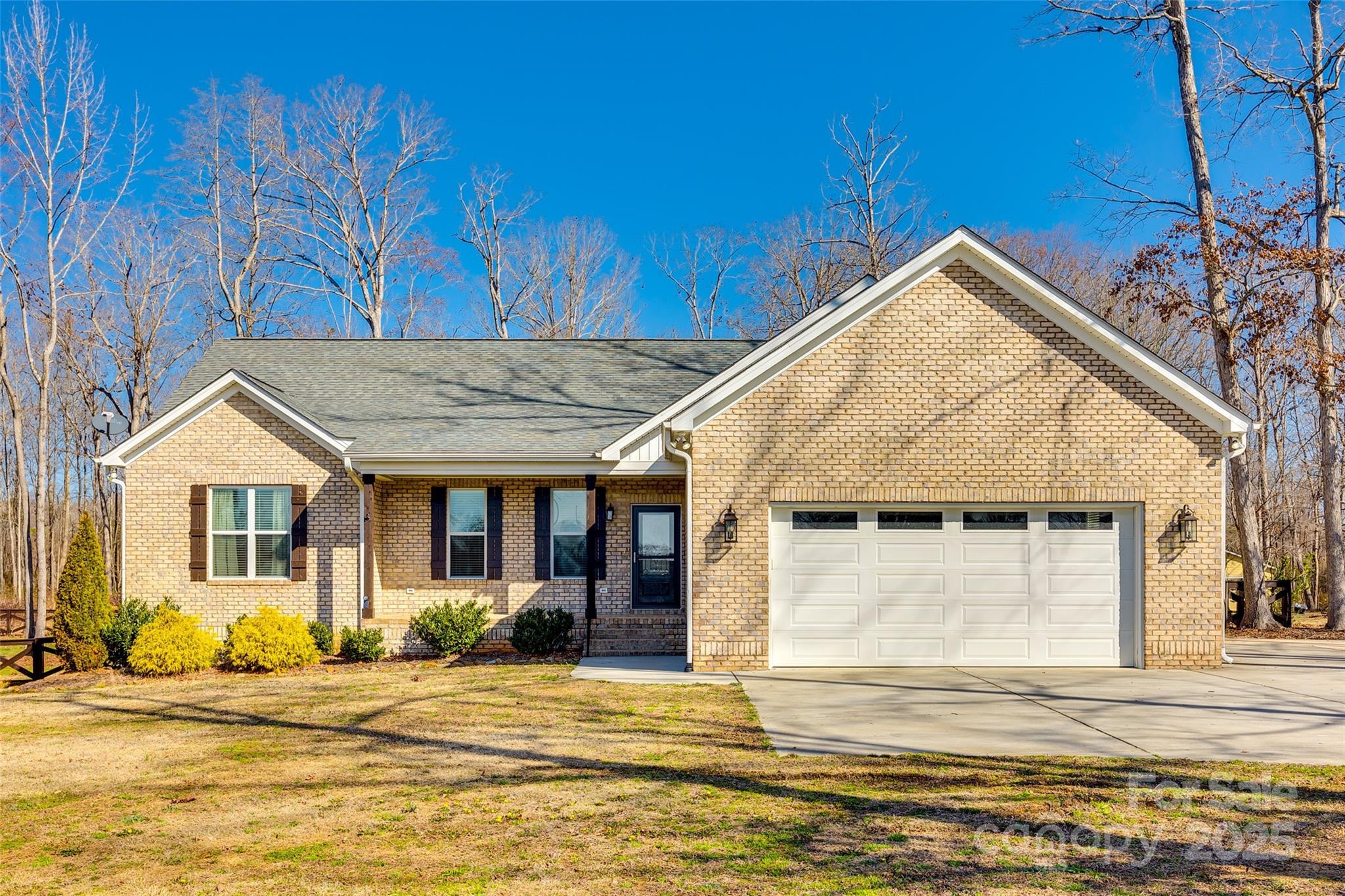 Custom Full brick Ranch home on a sprawling 2.34 acre lot with lovely landscaping! This Home offers great finishes throughout including hardwoods throughout the main living area, a beautiful kitchen with granite counters, subway backsplash, undermount lighting, and stainless steel appliances, walk-in pantry, custom fireplace, tankless water heater, screened in porch, and professional landscaping. The family room has a lovely stone fireplace and offers an open concept living area. All bedrooms are on one side of the home for convenience and have brand new carpets just installed. The primary bedroom has a large spa like en suite with dual vanities, walk-in shower and a separate water closet. Step outside to the relaxing screened in porch overlooking the patio and professional landscaping around the fenced in back yard with mature natural hardwoods. The lot is very spacious with over 2 acres!