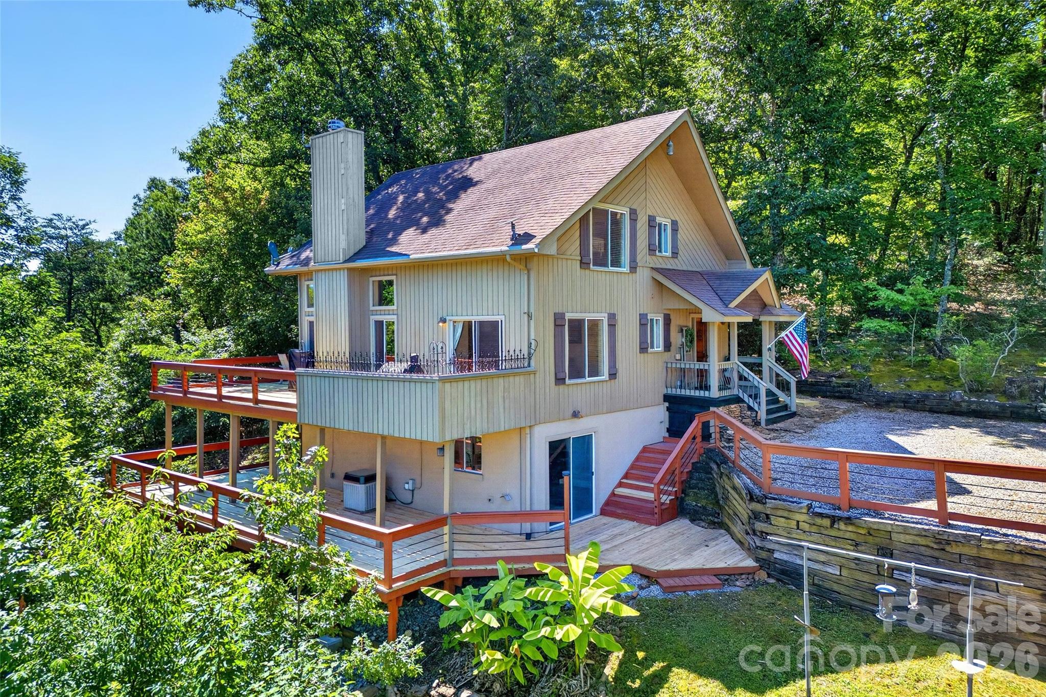 Perched on 3.6 private mountain acres in Pinnacle Ridge South, this custom mountain retreat offers the perfect blend of long-range views, privacy, and flexible living spaces—all just 20-25 minutes from Marion, Rutherfordton, and Forest City.

From the moment you step inside, the soaring tongue-and-groove vaulted ceilings, dramatic stone fireplace, and wall of windows create a true mountain-lodge atmosphere. Custom built-in bookcases span the great room, while natural light pours into the open living and dining areas. Step outside onto the brand-new upper deck and take in layered mountain views stretching across multiple ridgelines.

The thoughtfully designed floor plan offers three bedrooms and three full baths with a bedroom and bath on every level, creating privacy for owners and guests alike. The upper-level primary suite is currently used as a home office and features its own ensuite bath, making it an ideal retreat with room to work, relax, and enjoy the peaceful mountain setting.

The finished lower level expands the home's versatility with a private bedroom, full bath, direct deck access, and an additional Bonus Area featuring over 400 square feet. This area offers a recreation and gathering space that is  currently enjoyed as a game room and media lounge with direct access to the lower deck. Although not counted in the home's heated square footage, the owner states the area stays surprisingly comfortable year-round, requiring only a small supplemental heater during cooler winter weather.

Outdoor living is where this property truly shines. Brand-new decks on both levels create multiple spaces for entertaining, dining, and enjoying the cool mountain air. Whether you're watching the sunrise over the ridges, relaxing beneath the stars, or taking in the distant glow of city lights below, every season brings a new perspective from this exceptional setting.

The home is being offered mostly furnished, making it an outstanding opportunity for a full-time residence, vacation getaway, or short-term rental investment. Short-term rentals are permitted, and the layout is well-suited for hosting guests while providing privacy across all three levels.

Additional features include hardwood flooring, custom wood cabinetry, a detached storage building/workshop, abundant storage throughout. 

If you've been searching for a property that combines privacy, views, character, and income potential, this move-in-ready mountain retreat delivers it all.