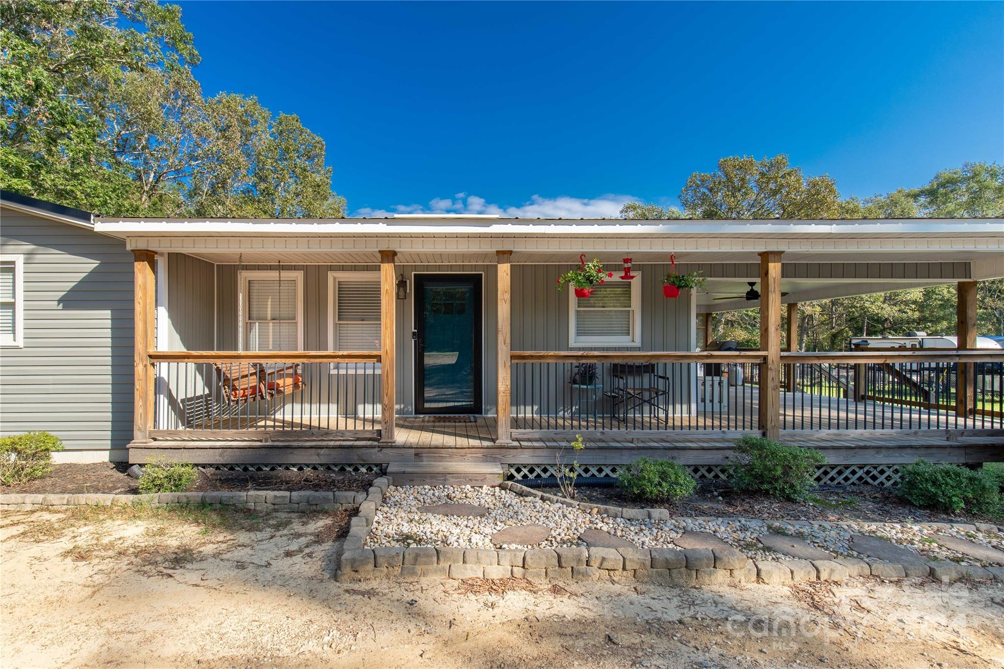 This beautifully maintained 3-bedroom, 2-bathroom home is nestled on over an acre in the highly desirable Buford area. Enjoy the tranquility of nature from your spacious wrap-around porch or the screened-in porch. Inside, you'll find a modern, updated kitchen with new cabinets, backsplash, counter tops, and appliances to include a gas stove. The primary suite is a true retreat, featuring a large bedroom with tray ceilings, two walk-in closets, and a luxurious bathroom with an oversized ceramic shower, tub, and double sinks. You'll love the the accented shiplap walls throughout. Don't miss this opportunity to make this your forever home!