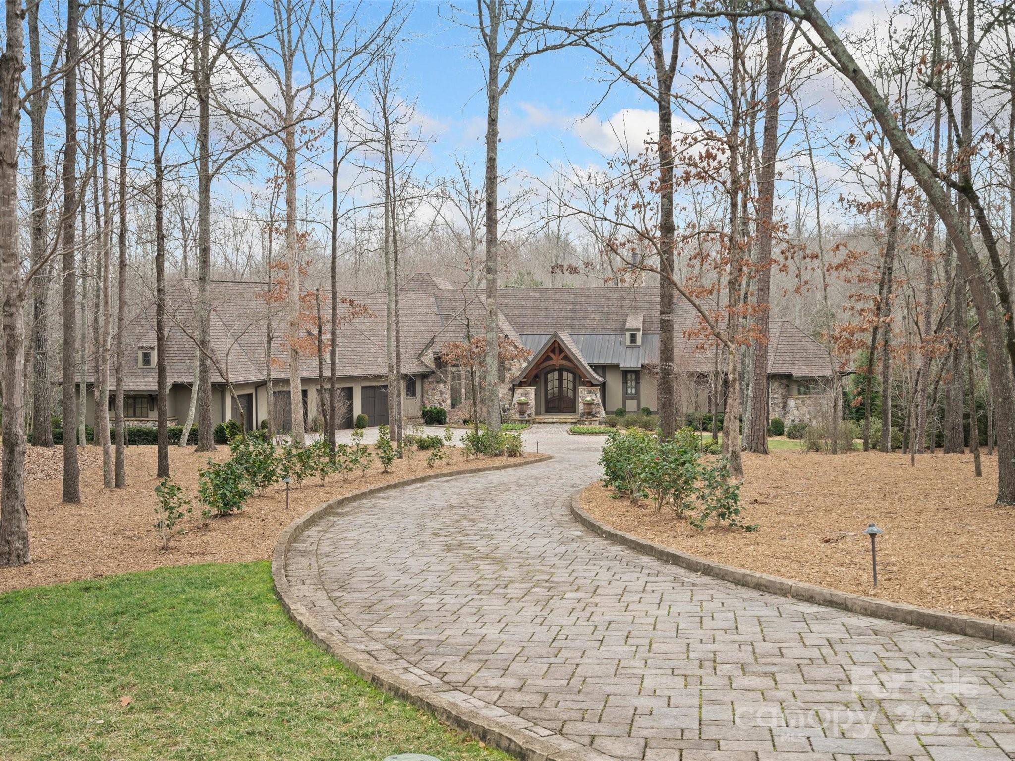 Absolutely stunning Arcadia home in the exclusive Sedgefield neighborhood on over 4 acres! This modern, rustic masterpiece will transport you to the Colorado rockies! The views of the pond are peaceful and relaxing. The gourment kitchen, with top of the line appliances, leads outside to the large covered patio with fireplace and grill. The master bath and closet are a dream! The basement has a kitchen, exercise room with equipment, full bedroom/bathroom, gorgeous office, and bonus room that could easily be a theatre room. There is plenty of storage in this beauty! It is the perfect place to entertain family and friends! This home is unique with a whole home generator, top of the line water filtration system, and Geothermal heating and cooling!  This home has it all! Come see yourself on the patio by the fire with the people you love. You will forget that you still have all the conveniences of Charlotte and Waxhaw at your fingertips! Are you ready to be transported?