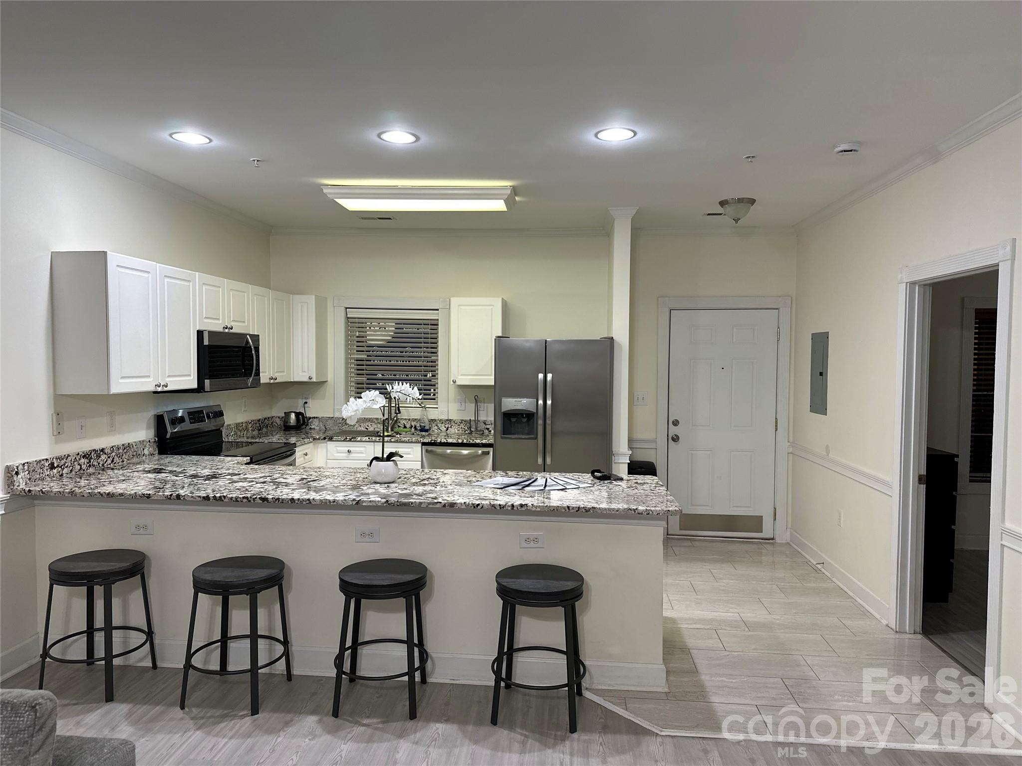 Don't miss the opportunity to see this stunning ground-level condo featuring 2 bedrooms and 2 bathrooms! The unit boasts brand new granite countertops, updated LVP flooring, ceramic tile, and fresh paint throughout. Included are stainless steel appliances, a washer/dryer, wooden blinds, and a Nest doorbell camera. The open floor plan seamlessly flows out to a freshly painted patio that overlooks one of the two community pools. Enjoy a prime location near restaurants, grocery stores, and a variety of retail shops. Heatherstone is also conveniently situated close to UNCC and just off Highway 485. Home warranty to be offered with accepted offer