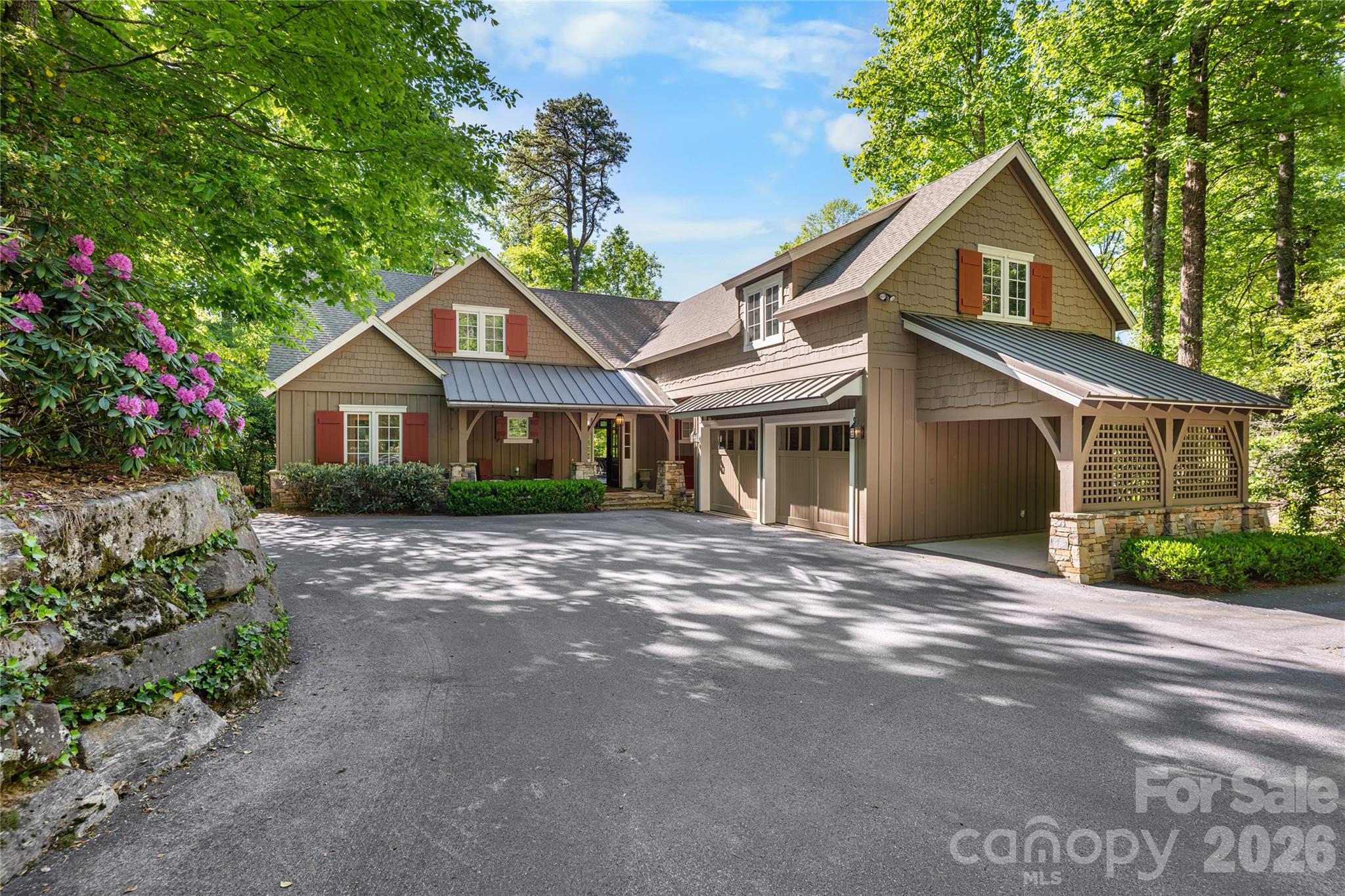 Welcome to an extraordinary lakefront retreat on Lake Toxaway, thoughtfully designed by renowned architect Allen Brown and expertly crafted by John Holbrook. Set on a rare flat lot with easy access to a private dock, this home blends timeless mountain charm with relaxed lakeside living.
Inside, the spacious floor plan features 4 bedrooms and 4.5 bathrooms, designed for both comfort and entertaining. The main-level primary suite is a true sanctuary, complete with exposed beams, dual walk-in closets, and a spa-like soaking tub. Upstairs, generously sized guest bedrooms provide plenty of space and privacy for family and visitors.
At the heart of the home, the chef’s kitchen is outfitted with a Viking range, abundant storage, and an open layout that flows seamlessly into the great room. A stunning masonry fireplace anchors the living space, creating a warm and inviting atmosphere year-round.
Step outside to enjoy the expansive outdoor living area, where a second fireplace overlooks the lake — the perfect setting for quiet mornings, evening gatherings, and unforgettable memories by the water. Elegant shiplap detailing throughout the main level adds warmth and classic mountain character.
Designed with both beauty and functionality in mind, the property also includes a two-car garage with a built-in workshop, additional covered storage for boats, bikes, or extra vehicles, and a large lower-level storage area ideal for kayaks, paddleboards, canoes, and all your lake gear.
Offering exceptional craftsmanship, breathtaking surroundings, and the best of Lake Toxaway living, this remarkable waterfront home is a place to relax, reconnect, and enjoy every season by the lake. Membership to Lake Toxaway Country Club is based on availability and application.