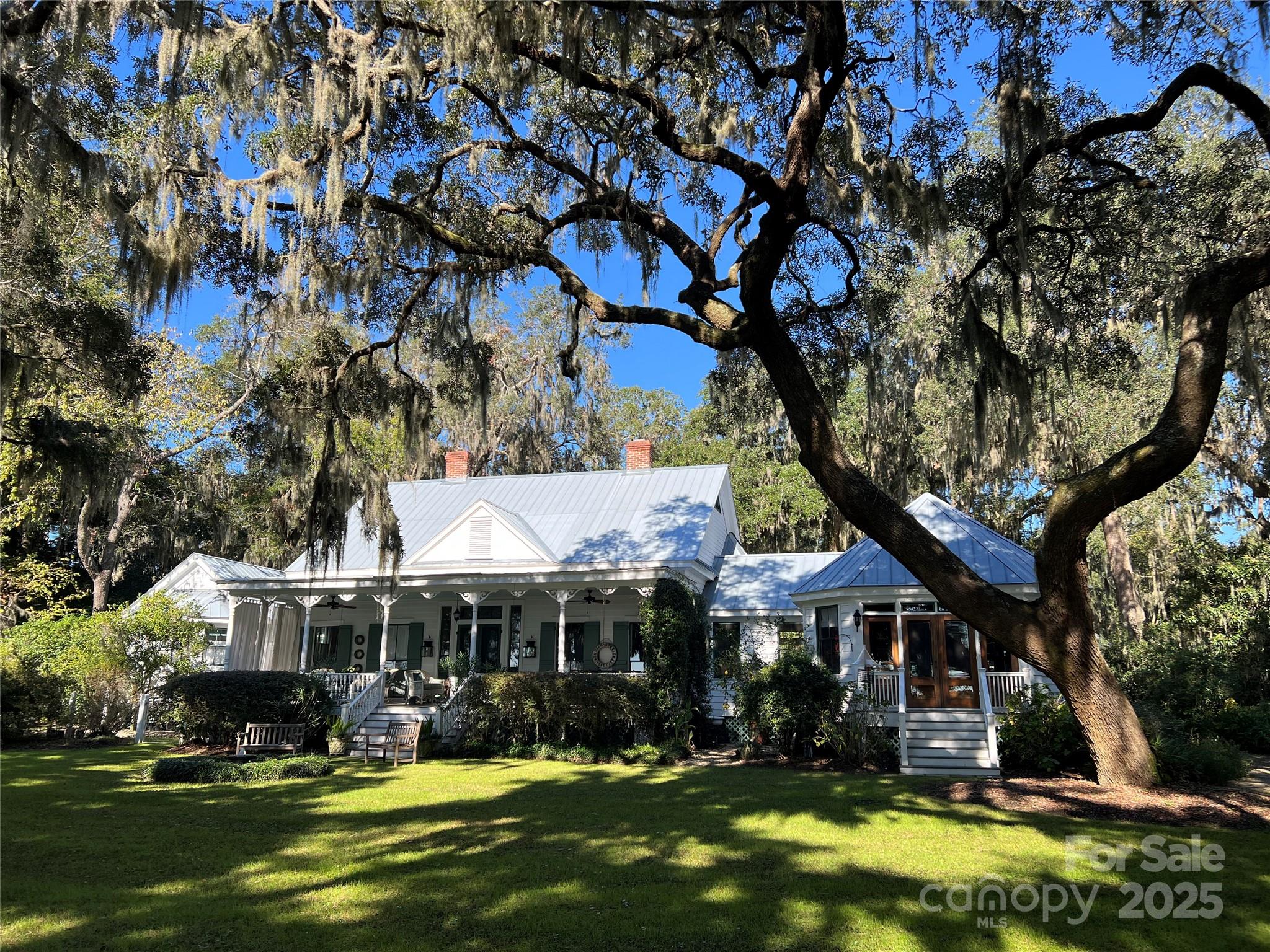 131 Pritchard Street, located in the historic heart of Bluffton, South Carolina, seemlessly blends rich history with modern luxury and offers an authentic Lowcountry experience with easy acces to the town’s vibrant art scene, fresh culinary offerings, river life, and unique “Bluffton State of Mind.” 

Nestled under 12 live oaks and overlooking the May River, the property includes a covered pier and a floating dock, offering opportunities for fishing, bird and dolphin watching, and enjoying the scenic views. The home's prime location allows residents and guests to walk or take a golf cart to the shops, restaurants, and galleries of historic Old Town Bluffton. It is a historic property that symbolizes the town's resilience, with a history spanning from the antebellum period through a Civil War destruction, a late 19th-century rebuild, and a modern renovation that preserved its original charm while adding contemporary luxury.

Dr. Paul Pritchard, (born 1819), a successful rice planter and a physician in the lower St. Paul’s Parish area of South Carolina built the first Pritchard House on the May River bluff as a summer home for his wife, Martha Catherine Kirk, and their six sons. Like most of Bluffton, the Pritchard House was burned by Union forces in 1863. 

In the mid-1890s, one of Dr. Pritchard's sons, Charles Teft Pritchard, rebuilt the house on the site. He strategically oriented the house to face the May River to catch the prevailing breezes. At the time, access to the home was only by ferry as there were no established roads. Meaning what was traditionally considered the front of the house is actually the rear. The new home was built in a Carolina-style farmhouse with Queen Anne elements. 

After being abandoned and overgrown for more than 50 years, the house was "lovingly restored" by the new owners, who discovered the property while on their honeymoon in 1995. The house has since undergone remarkable renovation and restored under the guidance of a preservation expert following National Register of Historic Places guidelines. The home features original heart pine construction, 12-foot beadboard ceilings, and tall, pocket-style windows. It is uniquely canted toward the prevailing southwest breeze with wider back rooms, uses a "wind catcher" design for climate control, circulating cool air from beneath the pier foundation and allowing heat to rise.

The 1990s restoration added east and west wings, connected by breezeways to maintain airflow and views, replicating the original design. The new wings accommodate a primary bedroom suite with two walk-in closets and oversized bathroom, and the other a large kitchen and dining room. Modern upgrades and amenities have since been incorporated, such as new Viking appliances, mahogany doors, a renovated laundry room, updated guest bath and herringbone brick floors in the mud room.

The home, featuring four rooms with fireplaces flanking a wide central hall and a riverside porch, had uncompromising stewardship by all owners, from the Pritchard’s to the restoration owners in the 1990’s, and on to the current master gardener owner.  All have maintained the culture of The Pritchard House while adding to the graciousness of this incomparable home.
 
The property, which includes the main house and a separate two-bedroom guest cottage (originally a boarding house built by Charles Pritchard's widow in 1905), is located in the Old Town Bluffton Historic District, which was granted National Historic District status in 1996. In recent years, the guest cottage has been a 5-star rental through Airbnb. The property is well-known and featured on local historic walking tours.

The property was under contract, unfortunately, buyer’s contract on their home did not go through.