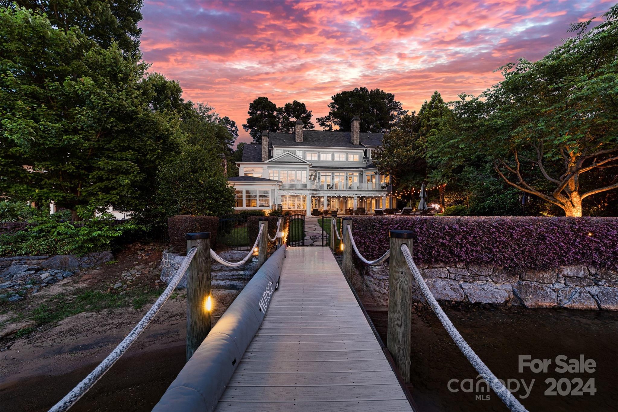 Nestled along the serene shores of Lake Norman, this waterfront masterpiece offers an unparalleled blend of luxury, convenience, and natural beauty. Just a short bike ride from both the prestigious Peninsula Country Club and Yacht Club, this custom built 5 BR home has it all. Large glass doors throughout offer panoramic views of the shimmering waters beyond. A gourmet kitchen and open-concept living area with multiple fireplaces provides the perfect setting for intimate gatherings and festive celebrations alike.The lower level is perfect for entertaining with a bar, fireplace, movie room, gym, fully climate controlled wine room and seamless access to the pool, lake and dock. Multiple porches and terraces beckon you to unwind and soak in the breathtaking views. Lounge by the sparkling pool, take a refreshing dip on warm summer days, or retreat to the pool cabana for shade and relaxation. As the sun sets, gather around the fireplace and savor the magic of lakeside living under the stars.