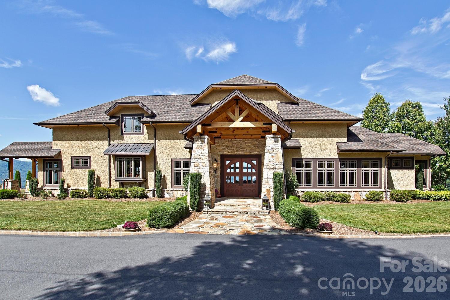 Mountain Modern Luxury with Sweeping Year-Round Views.  Experience refined mountain living in this stunning open-plan home designed to accommodate your ideal architectural style — Craftsman, Contemporary, or Mountain Modern. Set on approximately 3.7 acres atop a private flat ridge, this 5,484 sqft residence blends breathtaking long-range vistas with exceptional craftsmanship and comfort.   The main level showcases a spacious Primary Suite with a private sitting area, large walk-in closet, and a spa-inspired bath featuring dual lavatories, separate water closets, a soaking tub with panoramic views, and an open shower with body sprays, ceiling-mounted rain head, and multiple showerheads.  Chef's Kitchen with Sub-Zero and Wolf appliances, extensive "leather" granite throughout, pot filler above the stove, solid cherry cabinetry and a movable center island.  Two new dual fuel 4 ton HVAC systems in addition to radiant-heated Italian porcelain tile floor on the Main Level, solid Brazilian cherry wood floors on the Upper Level and staircases, vaulted wood ceilings, and Anderson 400 Series windows framing year-round mountain scenery. Upper Level boasts three ensuite bedrooms and a versatile flex space (currently an office/exercise area) offering privacy and flexibility. Outdoor living is elevated with a large, flat, landscaped yard, multiple gathering areas, fire pit and a grand pavilion — ideal for entertaining, weddings, or simply soaking in the views.  Owner financing available. Pavilion can easily be converted into a 3 car Garage.  Prime Location: Only 10 minutes to downtown Waynesville, 5 minutes to the historic Waynesville Inn & Golf Club, 30 minutes to downtown Asheville and 35 minutes to the Asheville Regional Airport.

See video and additional photos at:

http://iframe.videodelivery.net/742bfa9539f05eb344ce2538182f3bd9

https://www.thetravel.com/trade-asheville-north-carolina-for-underrated-smokies-gateway-town-waynesville/

https://www.facebook.com/share/r/1DcZTGKQsq/