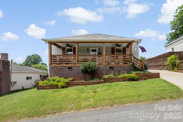 WOW! This home is absolutely stunning and full of thoughtful updates! Relax on the charming rocking chair front porch before stepping inside to a spacious, welcoming living room. The open floor plan creates the perfect space for entertaining family and friends. The beautifully updated kitchen features bright white cabinetry, stainless steel appliances, a stylish tile backsplash, granite countertops, and gorgeous LVP flooring. The spacious primary suite offers a beautifully renovated private bath, while the guest bedroom is tucked away at the back of the home with its own private bathroom, providing comfort and privacy for visitors. You'll love the beautiful light fixtures and carefully selected finishes throughout the home. A tucked-away office/flex space adds versatility, making it ideal for working from home, a playroom, hobby space, or whatever fits your lifestyle. Step outside to enjoy the large covered deck overlooking a private, fenced backyard with beautiful landscaping—an ideal setting for relaxing, entertaining, or simply enjoying the outdoors. Conveniently located near Riverside Park, scenic walking trails, downtown Cramerton, Goat Island, shopping, restaurants, and so much more, this home truly has it all!