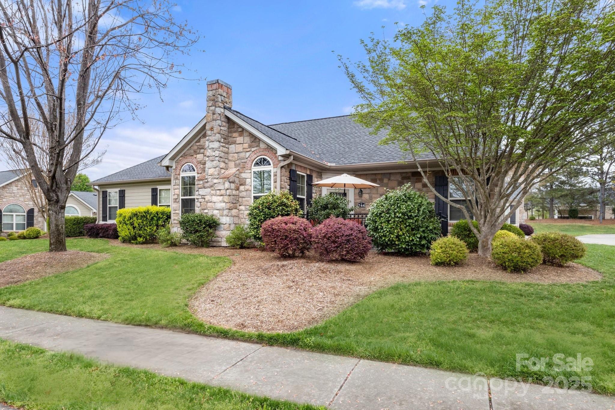 Prepare to fall in love with this former model condo in one of Tega Cay’s most sought after communities. This highly desirable floorplan features large MASTER SUITES ON BOTH LEVELS providing versatility for multi-generational living, comfortable guest stays & a live-in care giver. Open floorplan with vaulted ceilings & an abundance of natural light. Main level consists of a spacious master suite with walk-in closet, large guest bedroom, half bathroom, living room with fireplace, dining room, kitchen, laundry room & utility room/pantry. Ample storage throughout the home + pull down access to storage above the large 2 car garage. Walk to restaurants, shopping & the proposed Main Street District. Stonecrest Villas offers low-maintenance living & HOA includes water, sewer, landscaping, garbage collection, exterior/roof maintenance, access to common area & resort like amenities (outdoor pool, library, workout facility, clubhouse, parks & sidewalks). Easy access to I-77.