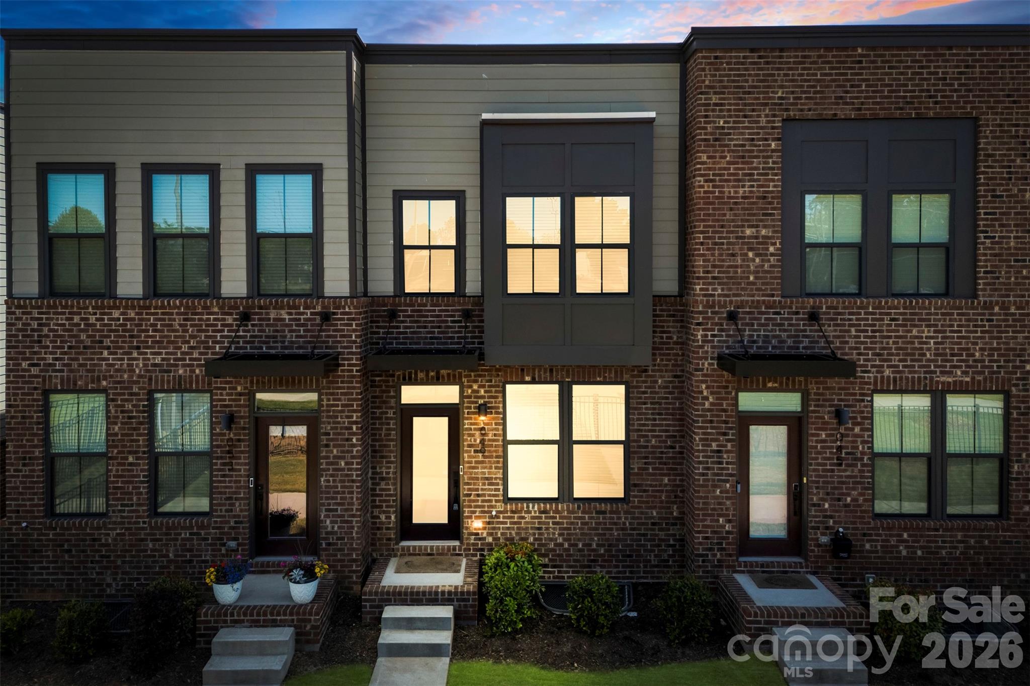 Sophisticated, move-in ready 2023 townhome in the heart of LoSo, offering luxury finishes, a flexible three-level layout, and unbeatable access to light rail, dining, and entertainment.

Enter the inviting open-concept main level, thoughtfully designed for both effortless entertaining and comfortable everyday living. The spacious living room flows seamlessly into the kitchen and dining area, which opens to a private balcony. The gourmet kitchen is the showpiece of the home, featuring quartz countertops, a large island and breakfast bar, stainless steel appliances with built-in microwave, shaker-style cabinetry, recessed lighting, and a striking herringbone tile backsplash. Durable luxury vinyl plank flooring runs throughout this level, and oversized windows bathe the space in natural light.

The lower level offers an ideal guest or office suite with a comfortable bedroom, full bathroom, generous closet space, and direct access to the attached 1-car garage. On the upper level, the serene primary suite boasts a spacious bedroom, large closet, and a spa-inspired ensuite bathroom with dual vanities and a beautifully tiled shower. An additional upper-level guest suite includes its own private ensuite with a tub/shower combination, while a conveniently located laundry closet completes this floor.

Situated in the vibrant LoSo area near the Woodlawn Light Rail Station, this townhome puts the best of Charlotte at your fingertips—Uptown sporting events and entertainment, popular breweries and restaurants, shopping, the airport, and easy access to I-77 and major thoroughfares. Enjoy low-maintenance, modern living in an exceptional location at an incredible value.

Enjoy an unbeatable location near the Woodlawn Light Rail Station with quick access to Uptown Charlotte, professional sporting events & concerts including the Panthers, Hornets, Charlotte Knights, and Charlotte FC, plus LoSo breweries, restaurants, shopping, the airport, I-77, and everything Charlotte has to offer!