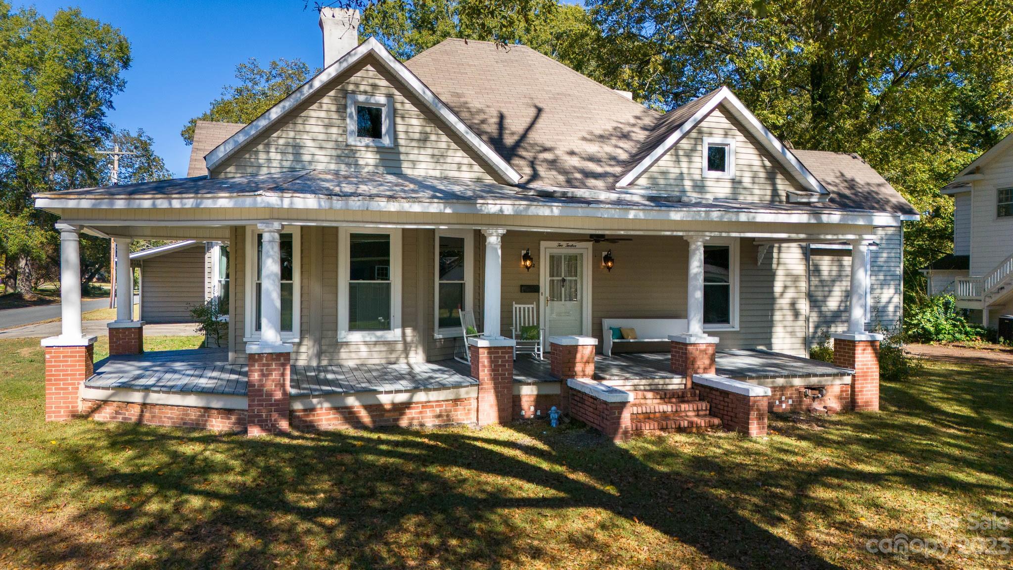 HISTORIC GEM! CHARMING STREET! TIMELESS CHARACTER!  This classic home offers quality features such as tall ceilings, porches galore and real hardwoods!  You will enjoy entertaining in the huge farmhouse kitchen with lots of natural light and 2 walk in pantries.  The spacious dining room has built ins, a wall of windows and is positioned right off the kitchen, living room and entry hall; which is large enough for a music area, office space/ play area/pet space.  The 3 bedrooms are very large and have 2 full bathrooms along with an attached office or exercise room. Updates include:  new flooring in bathroom, hardwoods refinished, painting, HVAC and roof a few years old and added double carport w/ storage.  Very large level lot.... All located in the heart of downtown Clover and walking distance to schools, grocery, restaurants, and shopping.  This is the small-town , good life you have longed for!!
Back on the market at no fault of the sellers - buyers financing fell through.