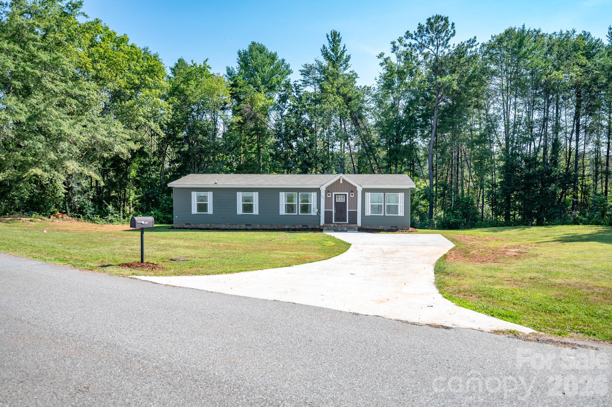 AMAZING LOCATION in Rutherfordton just outside city limits - 3 miles from Main Street! This 2020 doublewide is situated on a 1 acre lot on a peaceful street. Enjoy the best of both worlds with a quiet road while being minutes from shopping and restaurants. Conveniently located just off US-221 and very close to RS Middle and High schools.