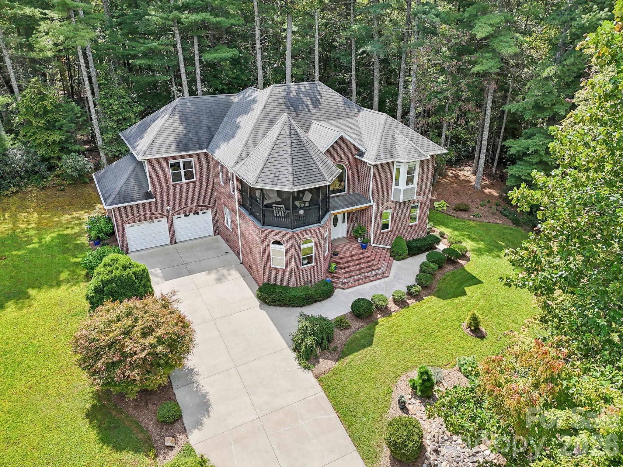 Tucked away on a quiet cul-de-sac in the sought-after Corbran Woods community, this custom mountain retreat offers the privacy of a wooded sanctuary with the convenience of being just minutes from Asheville. Surrounded by mature trees and thoughtfully designed for both everyday living and effortless entertaining, this home blends craftsmanship with comfortable elegance.

The light-filled interior features soaring ceilings, rich hardwood floors, and an open, inviting layout that flows seamlessly between the main living spaces. The spacious great room opens to screened porches and outdoor living areas, creating the perfect setting for morning coffee, evening gatherings, or simply enjoying the peaceful sights and sounds of the surrounding forest.

The generously sized primary suite serves as a private retreat, complete with dual walk-in closets, a spa-inspired bath, and an adjoining flex room ideal for a home gym, yoga studio, nursery, or private office. Additional bedrooms and versatile living areas provide plenty of space for guests, remote work or hobbies.

Whether you're hosting family and friends, working from home, or searching for a full-time residence or mountain getaway, this home offers exceptional flexibility to fit your lifestyle.

Located just a short drive from downtown Asheville, the Blue Ridge Parkway, local restaurants, shopping, and outdoor recreation, this property delivers the perfect balance of peaceful mountain living and everyday convenience.

Experience the space, privacy, and quality that make 15 Madelyn Lane a place you'll love coming home to.