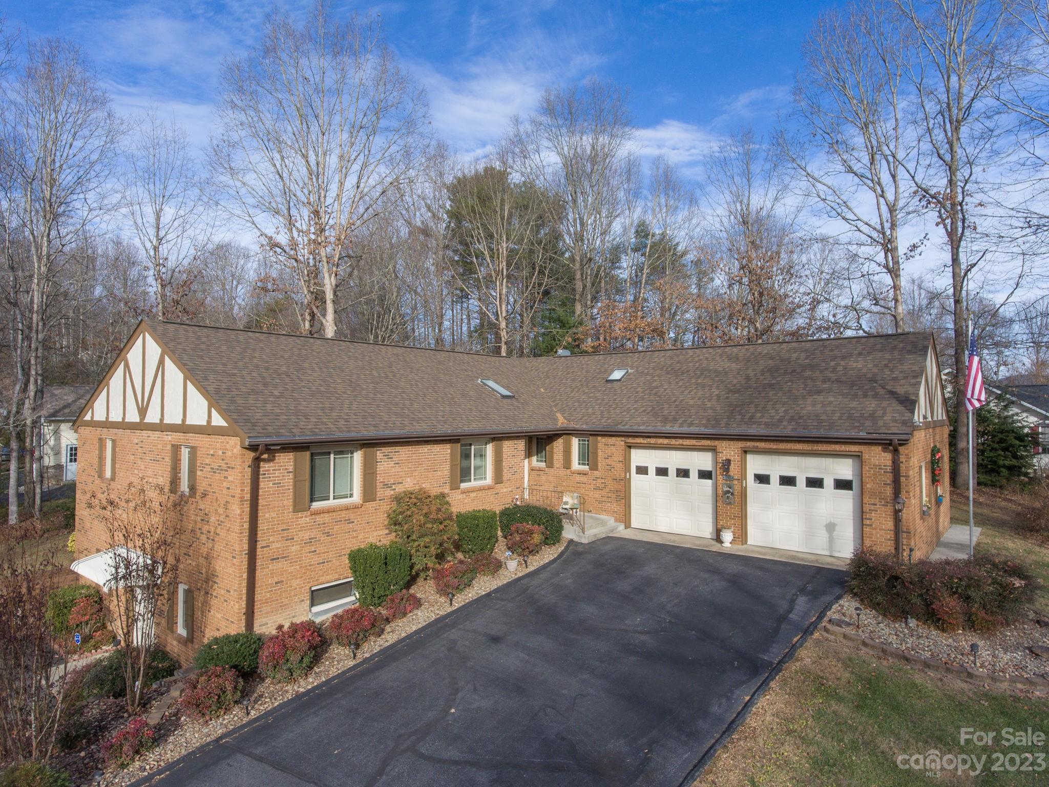 Lovely mostly brick home ( except for sunroom and tudor style eave area), with full basement. Large foyer, Living/Dining area has a vaulted ceiling and fireplace.  Good sized kitchen with pantry, laundry room with sink, wide hallway to bedrooms, 4 skylights, 2 walk in closets in primary bedroom. Finished and heated sunroom with door to open deck.
If you are a model train buff you will go crazy with the train room in the lower level.  Lionel train set up is just phenomenal and can stay with the house. See the photos.  The specialty train cars in the cases on the walls are not included but can be sold separately.  Owner also has a beautiful craft/sewing room set up (most craft supplies are for sale)..Shop is finished (except for concrete floor) and heated. Double door exterior access.  Main area of house needs some cosmetic updates, but new easy access shower was installed recently, HVAC in 2020, roof in 2016.