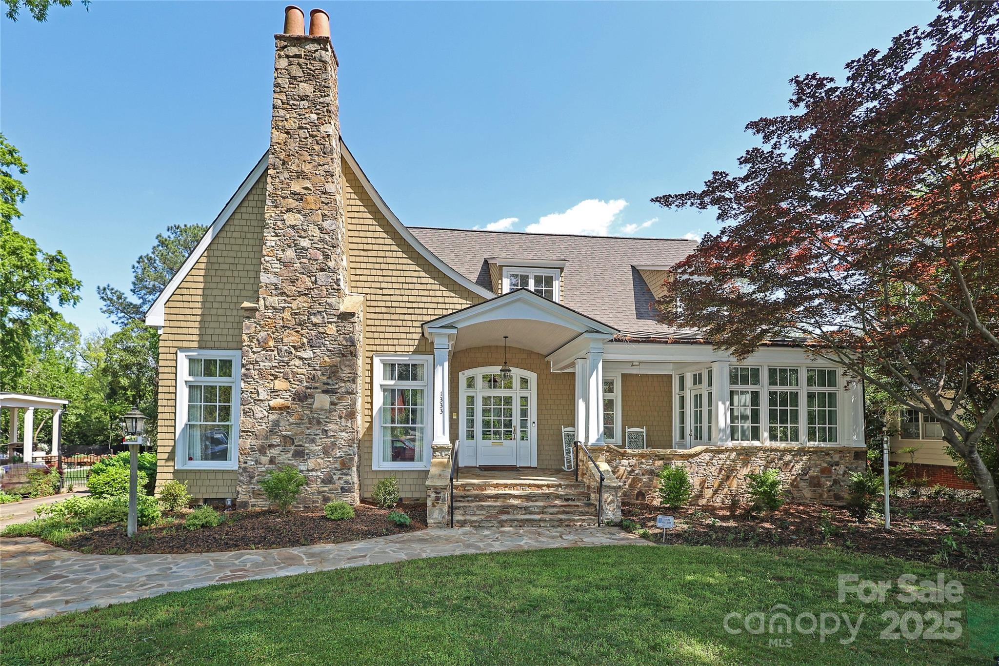 Beautifully updated home in Historic Dilworth! Refinished Brazilian hardwoods throughout the main level, which includes a formal living room with a 12-foot, coffered ceiling and formal dining room. A large, eat-in chef's kitchen has top of the line appliances, custom cabinets, walk-in pantry, and opens to a spacious den with a dry bar and built-in cabinets. French doors lead to a newly renovated outdoor area. First floor primary suite with his-and-her walk-in closets and a fully updated spa like bathroom. New roof in 2023 and main-level HVAC system in 2022. Brand new upstairs carpet, whole-house water filtration system, fresh paint inside and out, Tesla charger, new epoxy flooring in both the oversized two-car garage and the HUGE basement garage workshop. Tons of storage throughout including walk-in, two story attic with built-in shelves. Separate living quarters with full kitchen over the garage. With too many updates and unique features to list, this home is a must see!