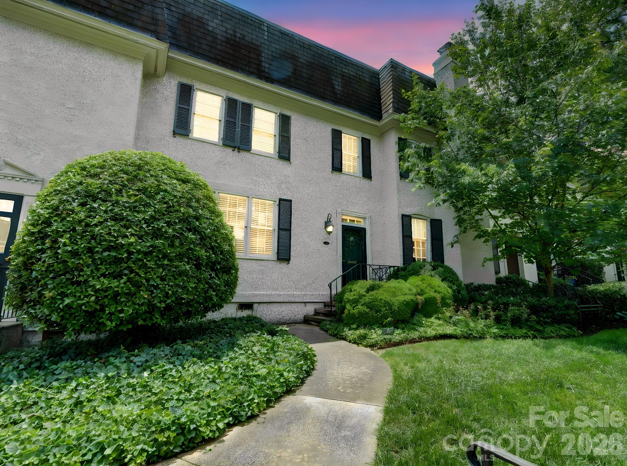 Fantastic address on Perrin Place, nestled in the heart of coveted Eastover. Freshly painted interiors & new carpet create a polished, move-in ready feel throughout this stylish townhouse. A welcoming foyer with adjacent coat closet and powder room opens to the spacious living room, complete with fireplace and built-ins featuring bookshelves and concealed cabinet storage. The formal dining room is ideal for entertaining, with French doors leading to the back patio and garden area. The kitchen is thoughtfully designed with soft-close cabinetry, illuminated glass-front display cabinets, a Bertazzoni gas range, and a walk-in pantry for exceptional storage. Upstairs, you'll find three bedrooms and two full baths, including the spacious primary suite with walk-in closet and private bath featuring a multi-head shower. Laundry is conveniently located just outside the bedrooms.Need storage? Pull-down attic stairs reveal more than 900 square feet of floored attic space, a rare find for townhouse living. All of this in an exquisite location, just a short stroll to some of Charlotte’s best shopping, dining, and everyday conveniences. Welcome home!