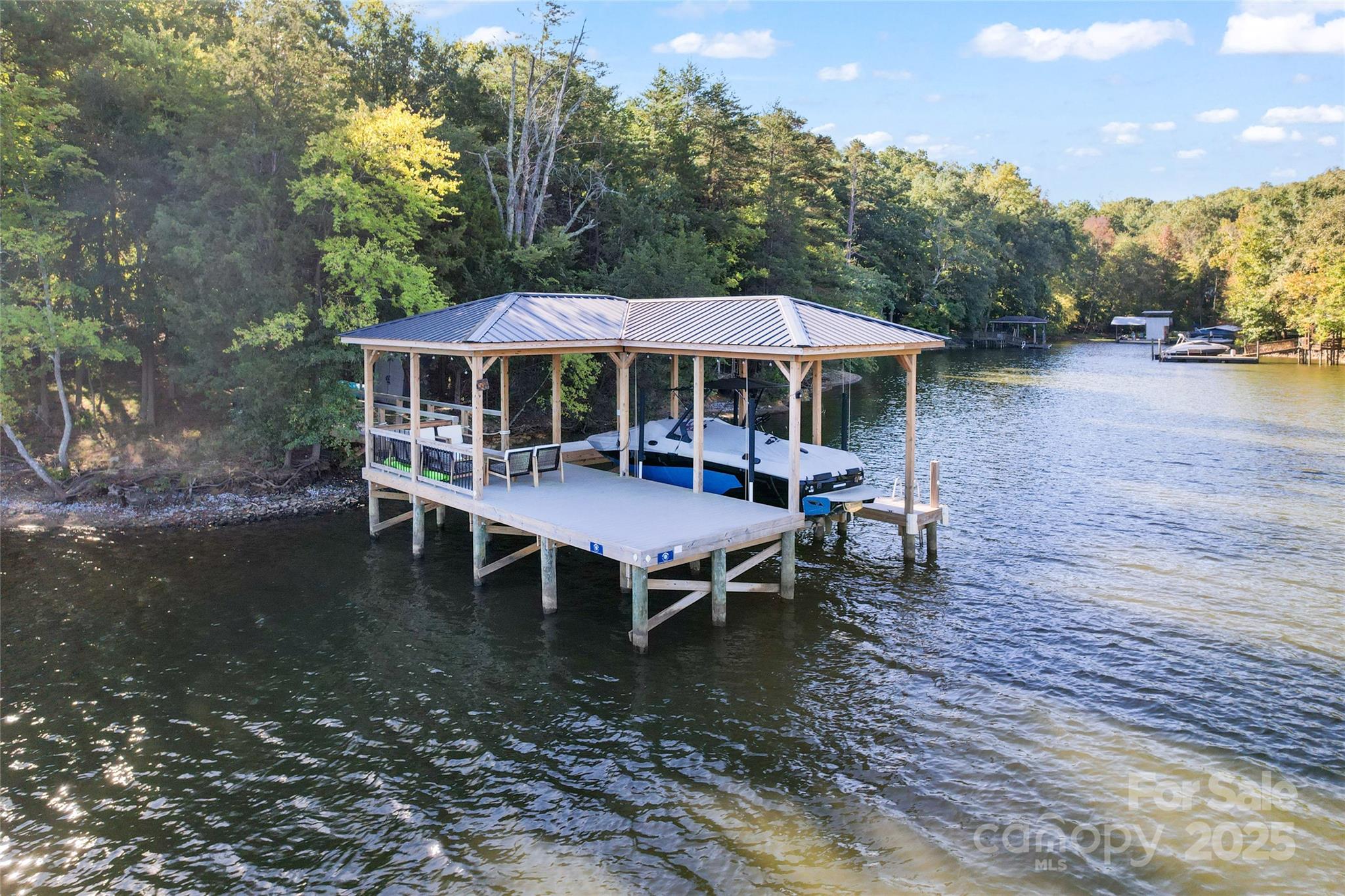 Get ready to be WOWED by this gorgeous, long-range panoramic view lot on Lake Wylie and zoned for TOP ranked Clover schools.  Conveniently located off of Charlotte Highway and right over the Buster Boyd bridge, this home is set back so you not only enjoy your private lot but you are tucked away in your own oasis.  This big water view lot, is located on a point so you enjoy deep water that is perfect for your recently built dock with cover and entertainment area.  The dock was built in 2023 and is fully permitted by Duke Energy and includes the boat lift.  The lot is fairly flat and perfect for a basement or slab home.  This lot allows you to immediately enjoy your lake access and the no time limit build with NO HOA gives you the flexibilty to build on your schedule.
See attachments for survey, Perc Test and Deed Restrictions.