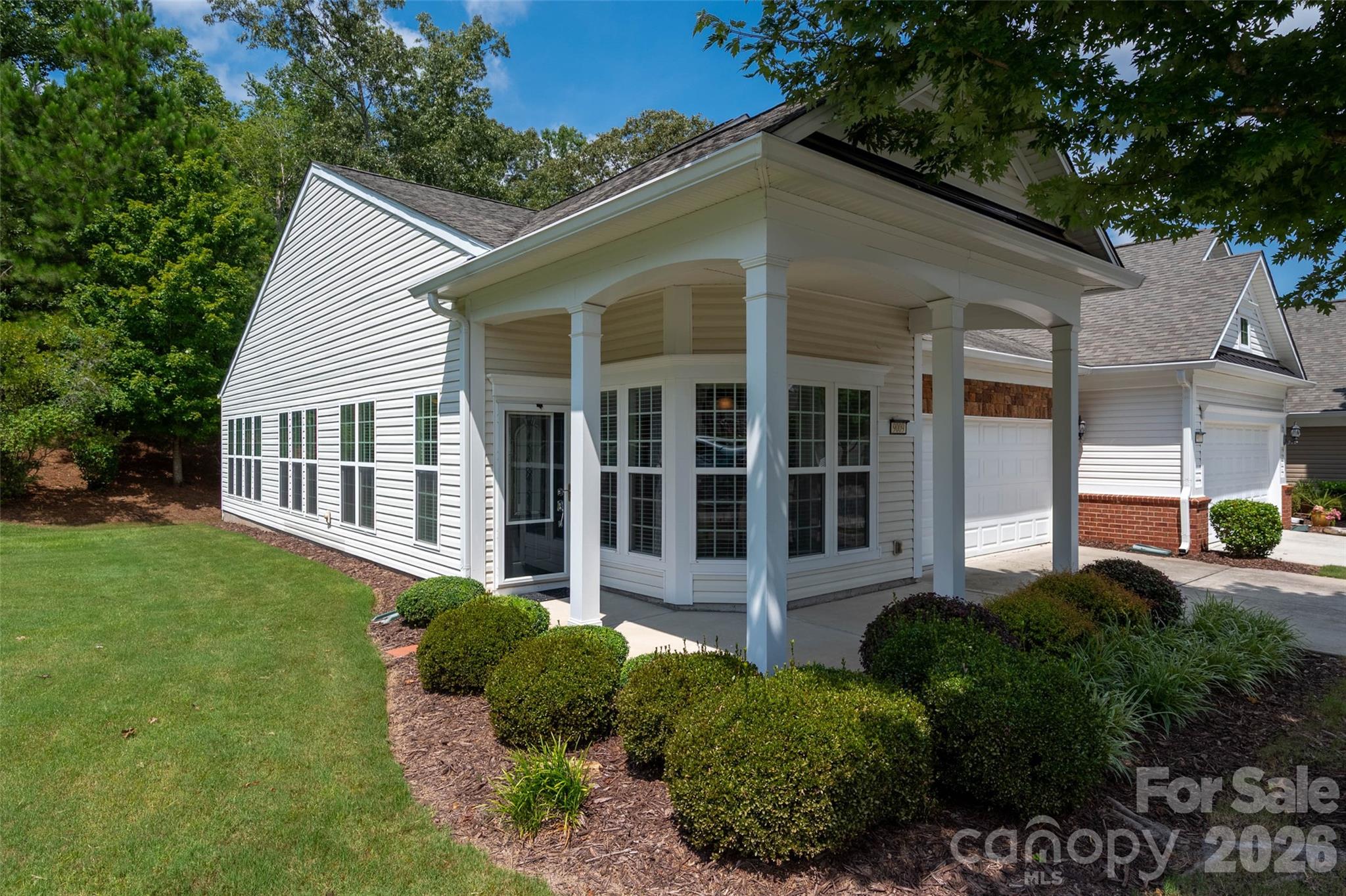 Welcome home to this beautifully maintained end-unit Kenwood Villa, gleaming w/ natural light, nestled against a wooded backdrop in highly sought-after Sun City Carolina Lakes! This move-in ready home boasts granite countertops & sleek black appliances. Enjoy casual meals in the sunlit breakfast nook or more formal dining in the dining area. Spacious living room, w/hardwood floors & abundant natural light. Primary bdrm features walk-in closet & en-suite bath. Generously sized guest bedroom could also serve as an office/hobby room. Step into the sunroom to unwind while enjoying views of the private, tree-lined backyard—a serene retreat surrounded by mature landscaping complete w/ large green common space next to unit for extra privacy. 

Completely immaculate & 100% move in ready! Active lifestyle community: 2 outdoor pools, indoor pool, 3 hot tubs, 15 lakes, trails, pickle ball, gazebos, social events galore & more! Come live your best live at Sun City Carolina Lakes!